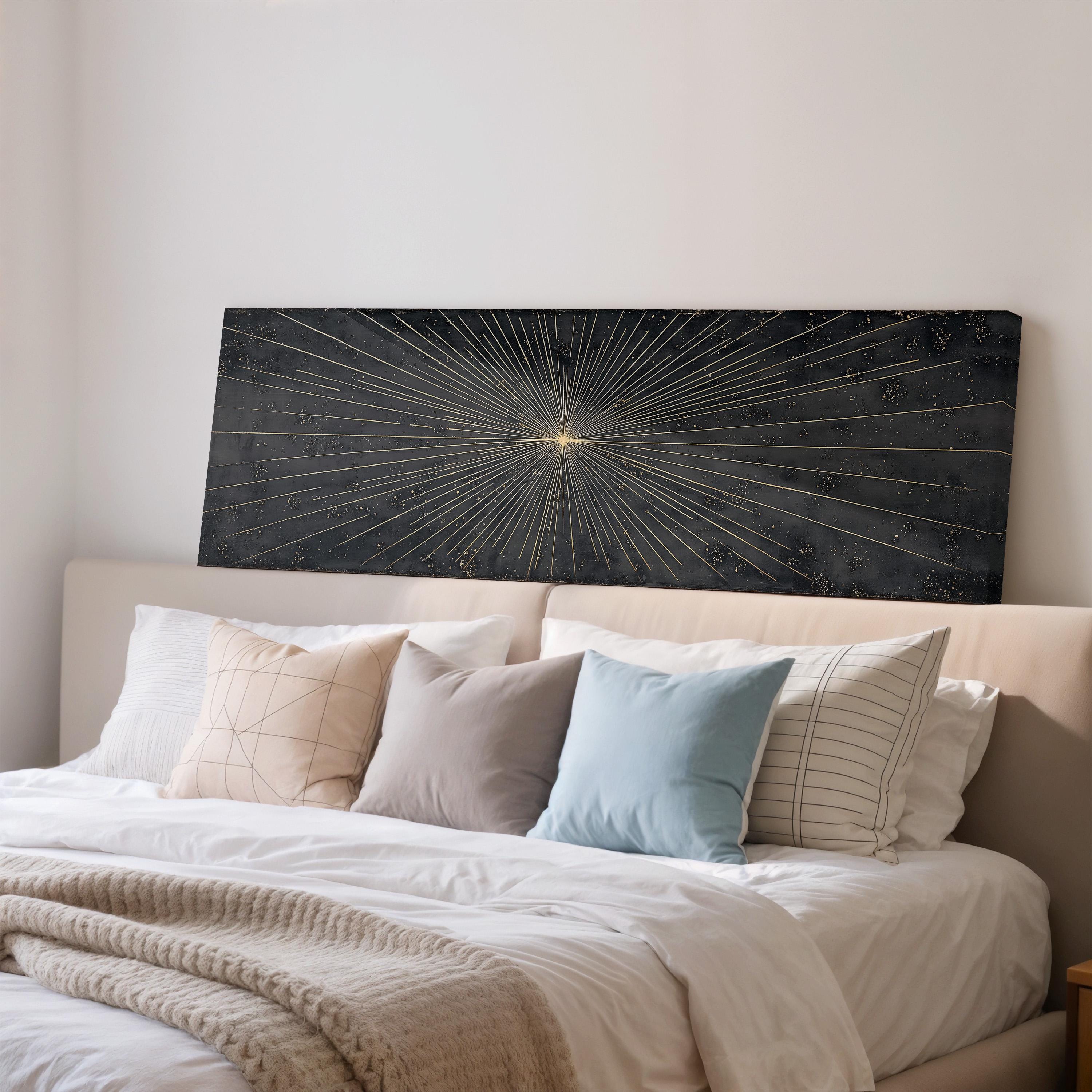 a well-made bed with a black headboard and a large abstract artwork featuring a starburst design on the wall above it.