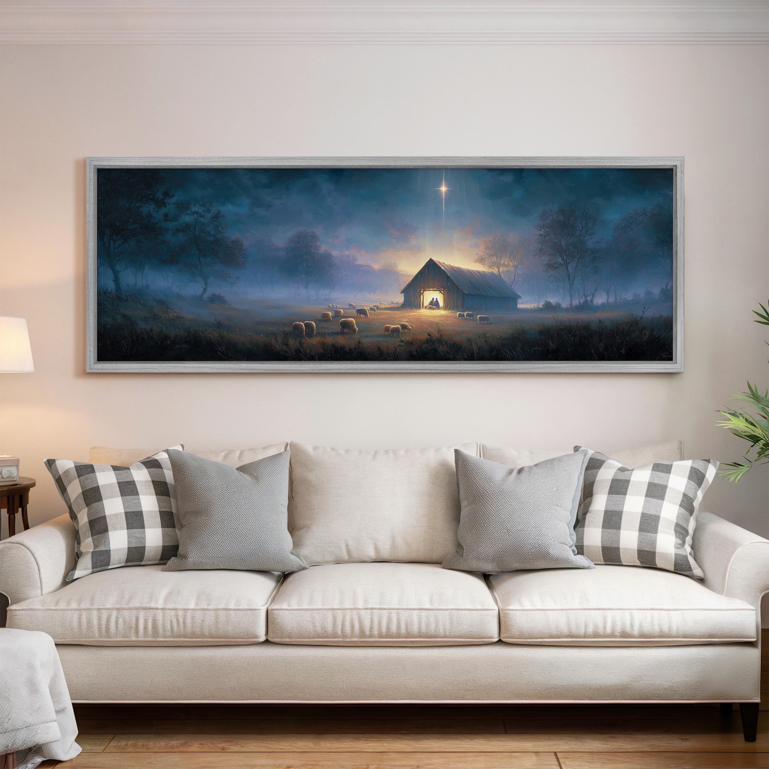 a large, framed painting of a serene countryside scene with a barn, trees, and a starry night sky. The painting is hung on a wall above a white couch with gray and white patterned pillows.
