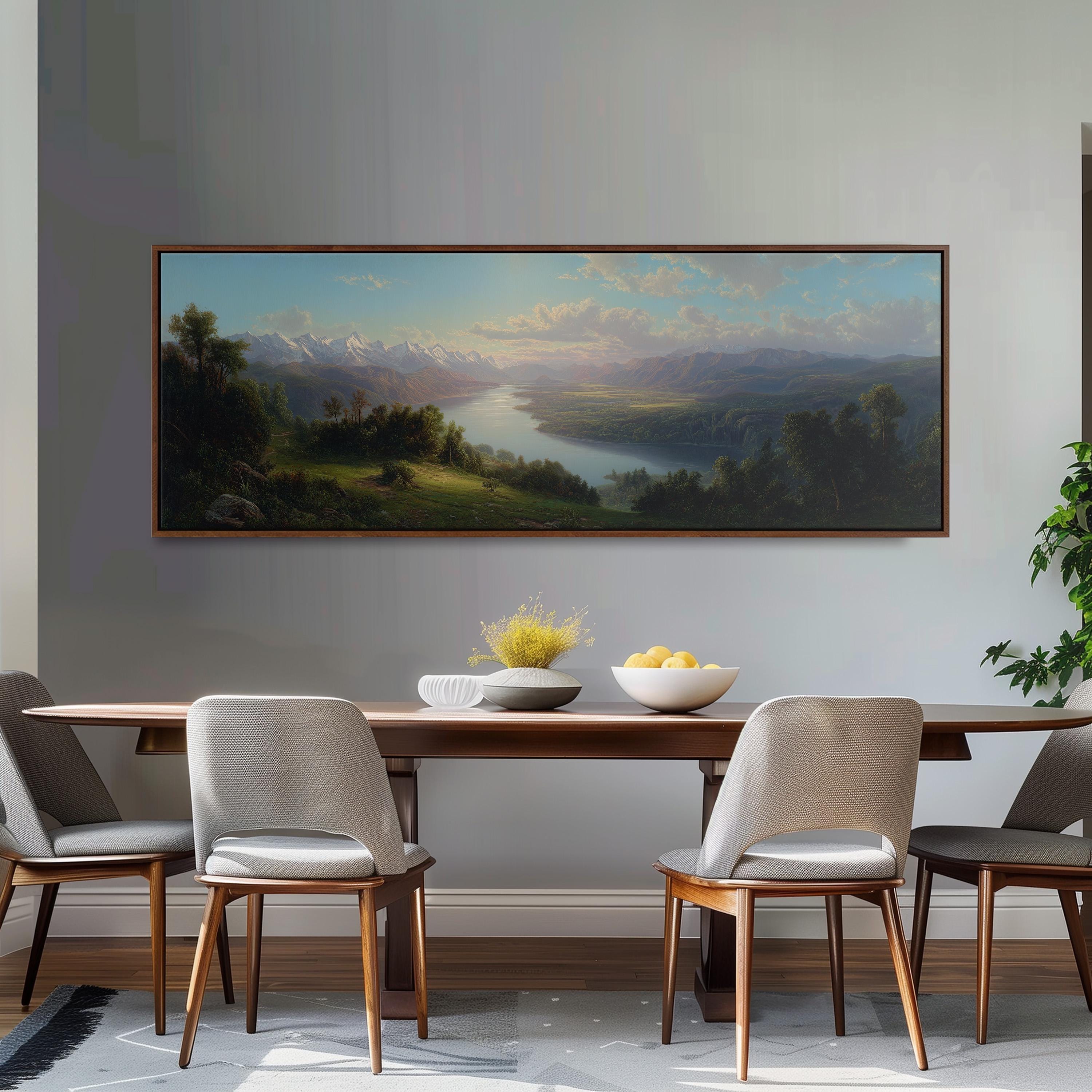 a large landscape painting hanging on a wall above a wooden dining table with four chairs. The painting depicts a serene mountain landscape with a river and lush greenery.