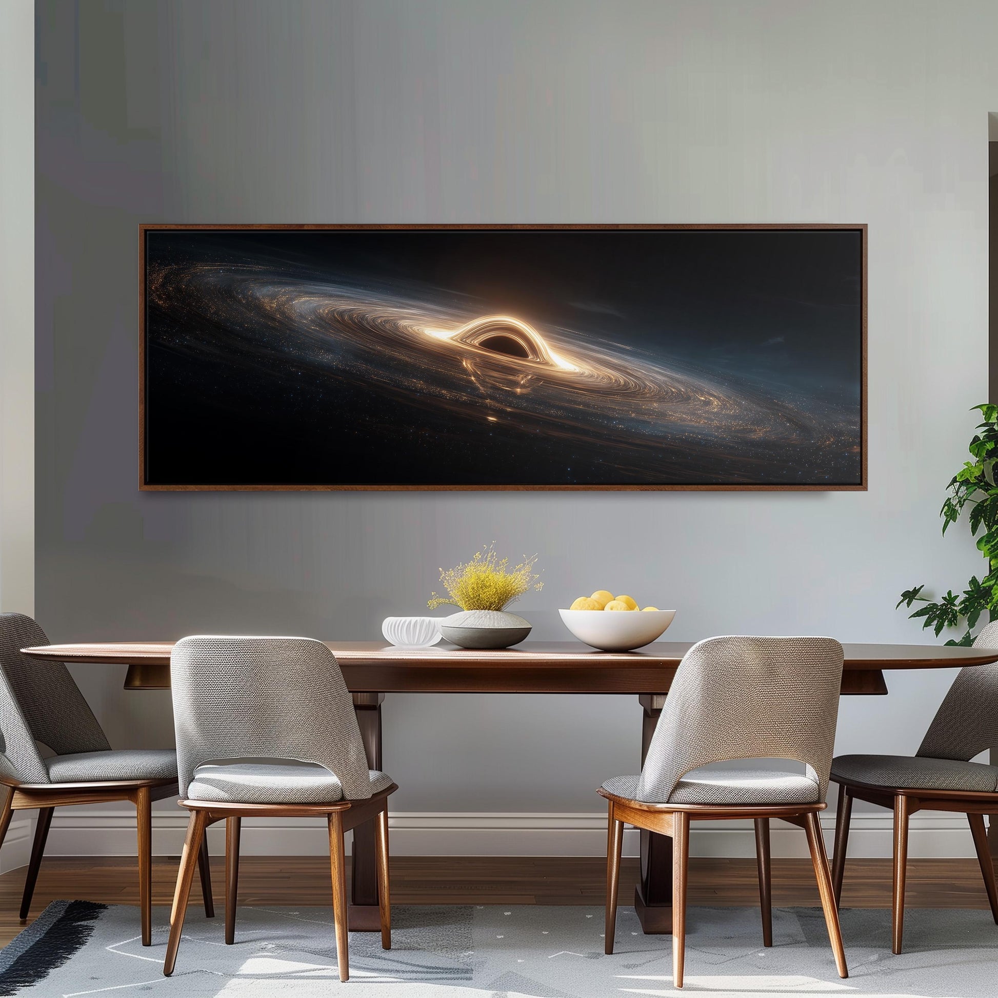 a dining room with a large, framed artwork depicting a black hole above a wooden table with four chairs. The artwork is hanging on a gray wall above the table.