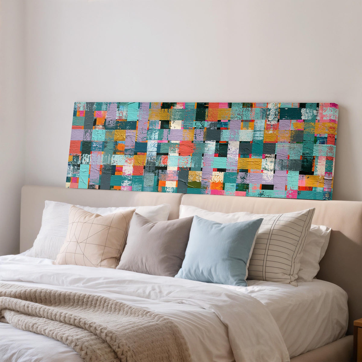 Woven grid of teal and pink blocks wide panoramic canvas print above a bed in a bedroom