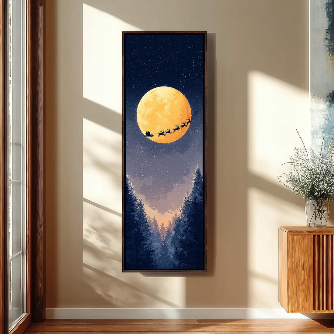a large, framed painting of Santa Claus and reindeer flying over a snowy landscape with a full moon in the night sky.