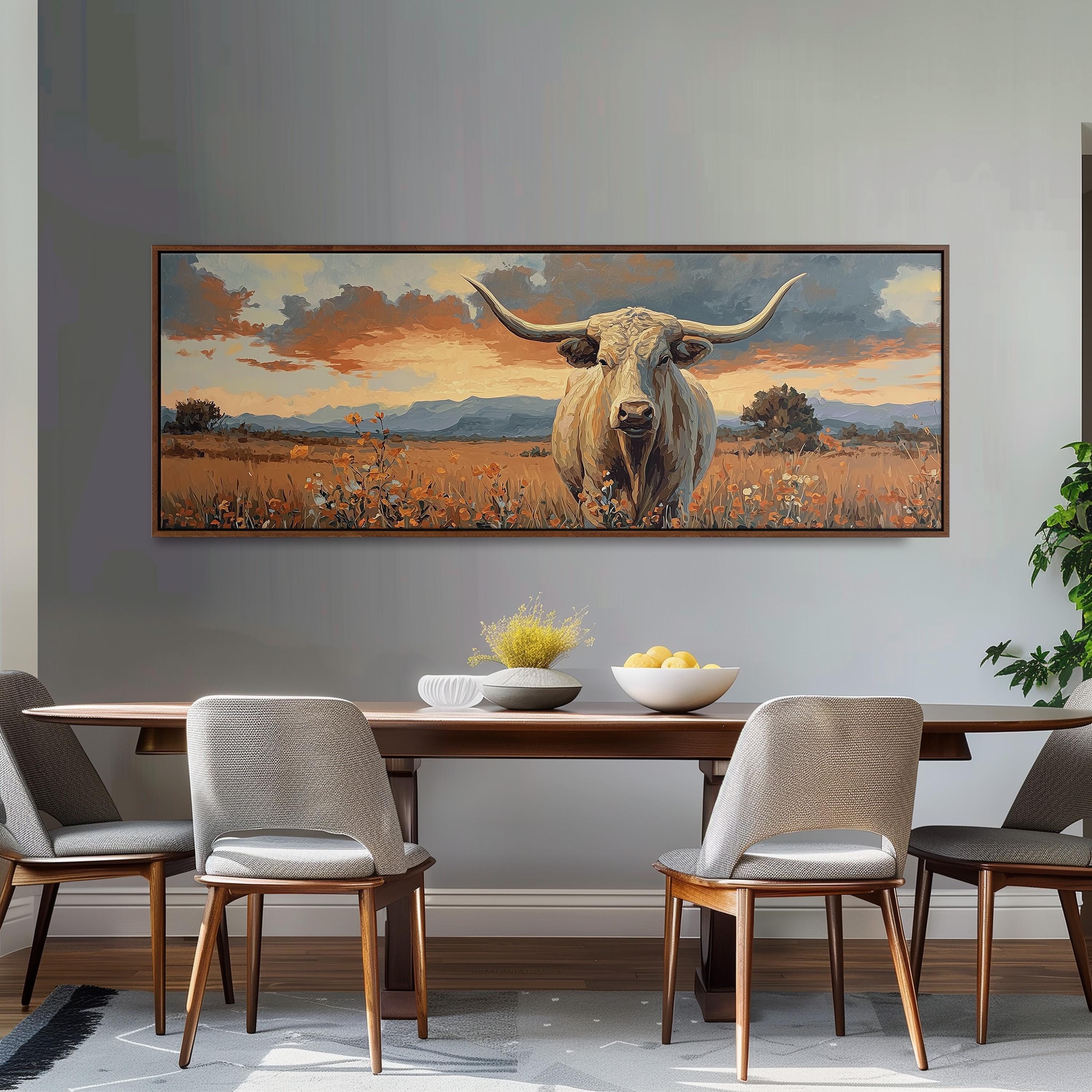 a large painting of a bull with horns, hanging on a wall above a wooden dining table with four chairs.