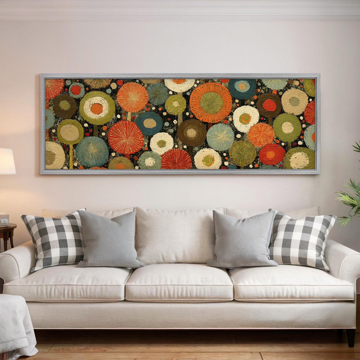 Layered circle dot pattern panoramic canvas print above a white sofa in a bright living room
