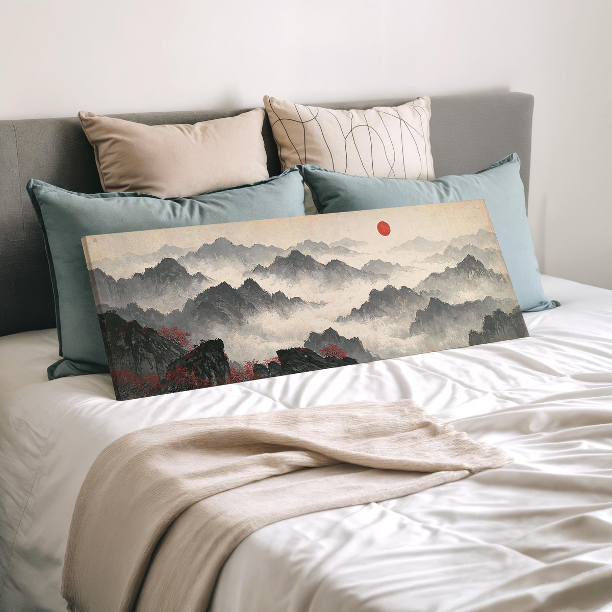 Misty ink mountains under a red sun wide panoramic canvas print laid on a bed to show its size