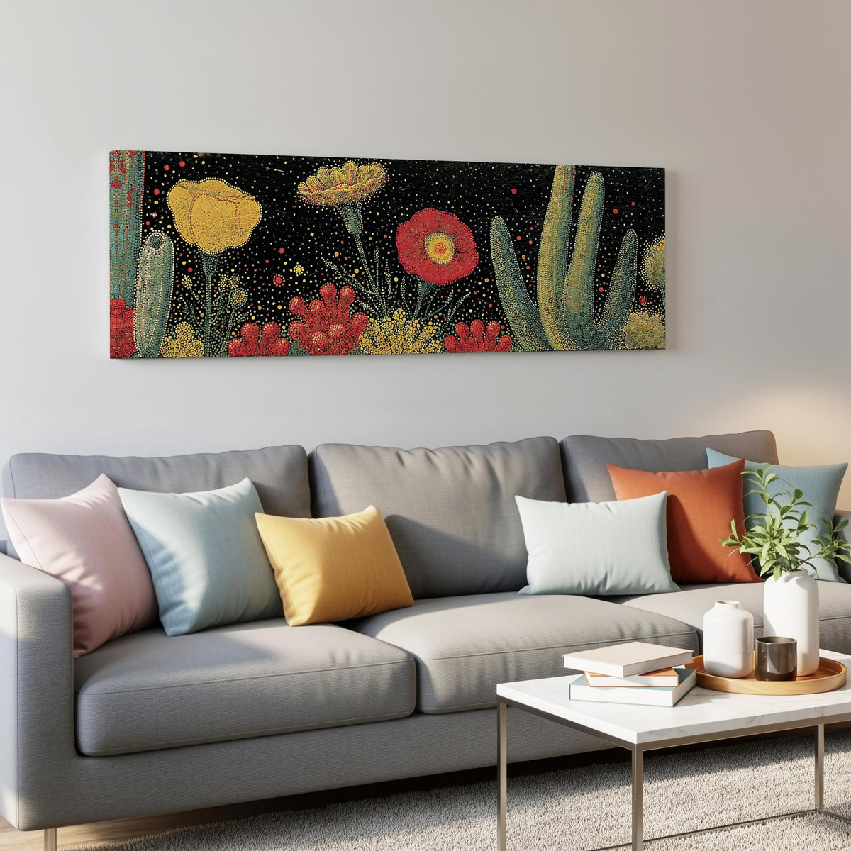 Desert blooms and cacti on black panoramic canvas print above a grey sofa in a living room
