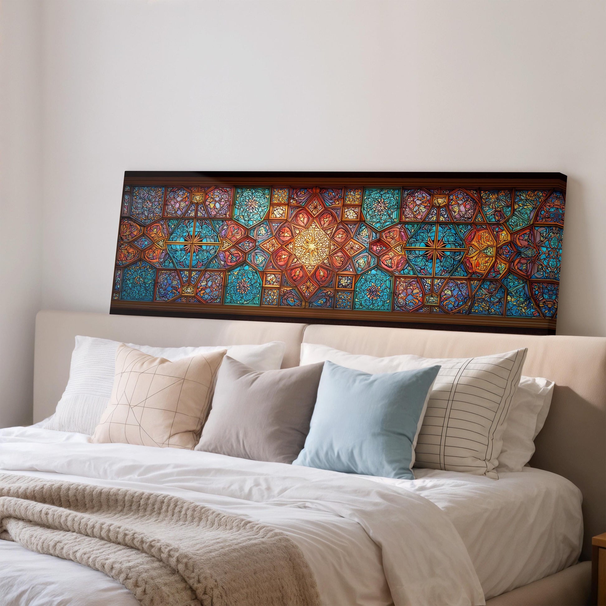 a large, colorful stained glass artwork displayed on a wall above a bed with white bedding and pillows.