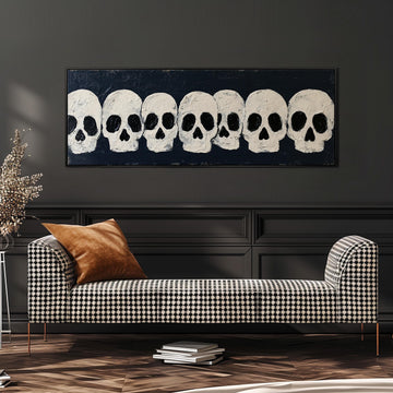 Row of white skulls on navy long horizontal canvas print above a sofa in a living room