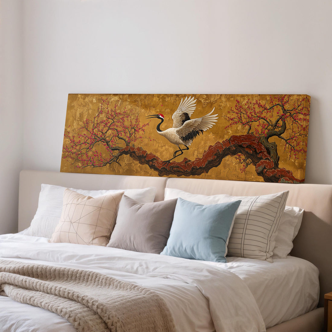 a dining room with a large painting of a crane in flight above a wooden table with four chairs. The painting is framed and hangs on the wall above the table.