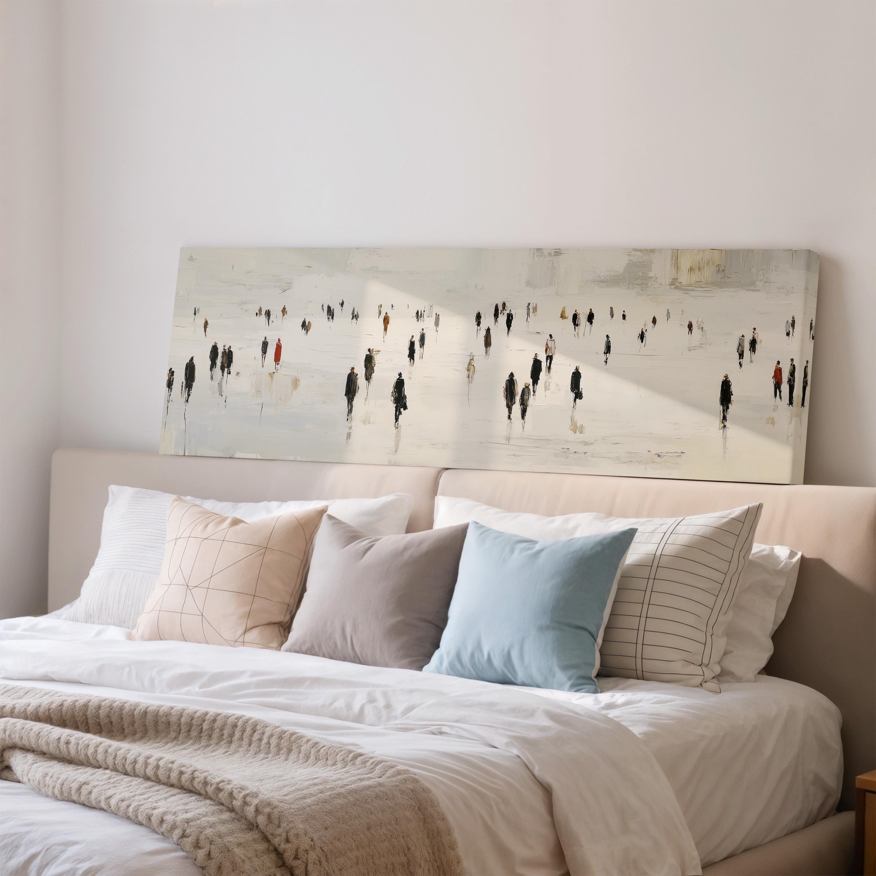 a large painting of people on a snowy landscape hanging above a bed with white bedding and pillows.
