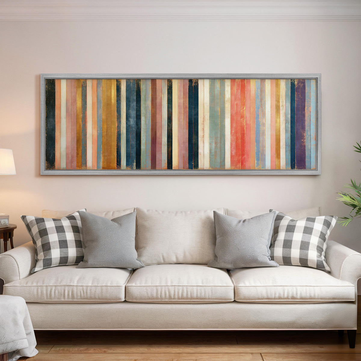 Blush, navy and gold gilded stripes panoramic canvas print above a white sofa in a bright living room