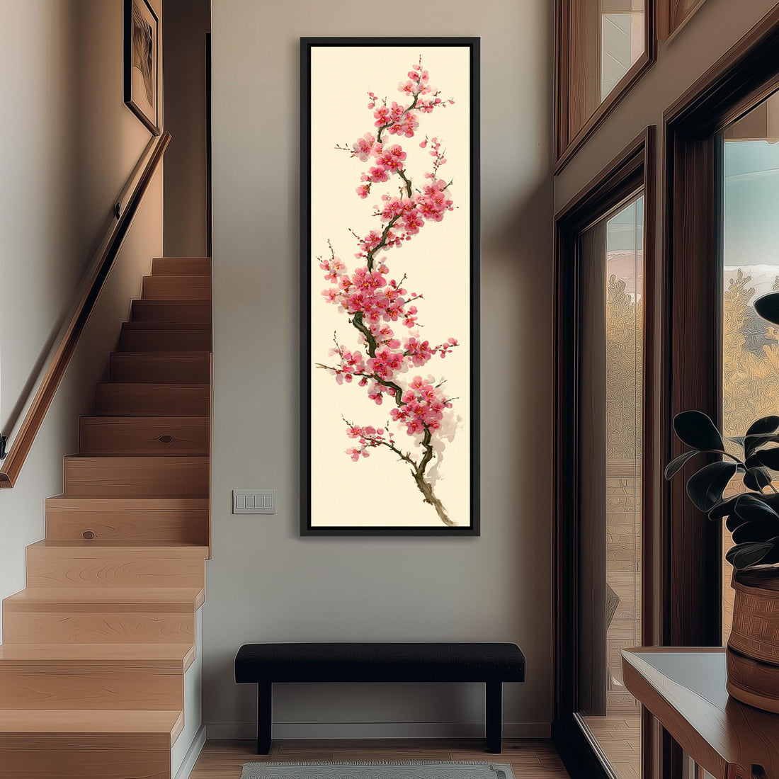 a large framed painting of a pink flower on a wall, with a wooden cabinet and a vase of flowers to the right of the painting.