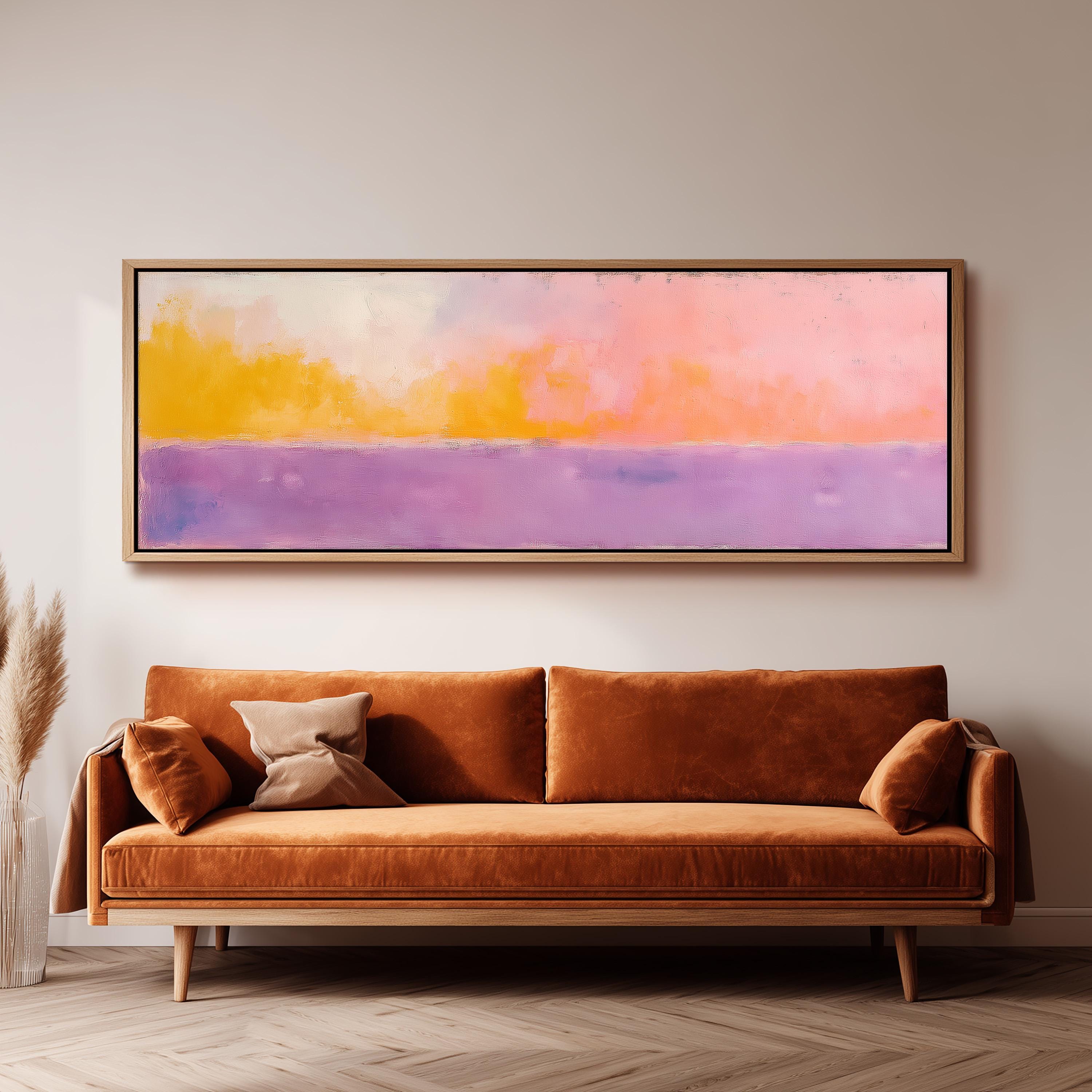 a large, rectangular painting hanging on a wall above a brown sofa with two pillows.