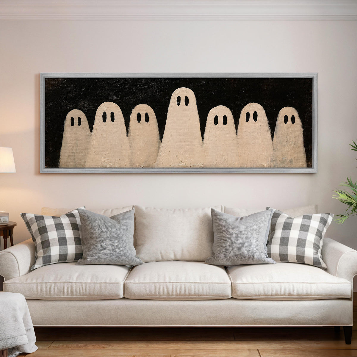 Friendly ghost gang panoramic canvas print above a white sofa in a bright living room