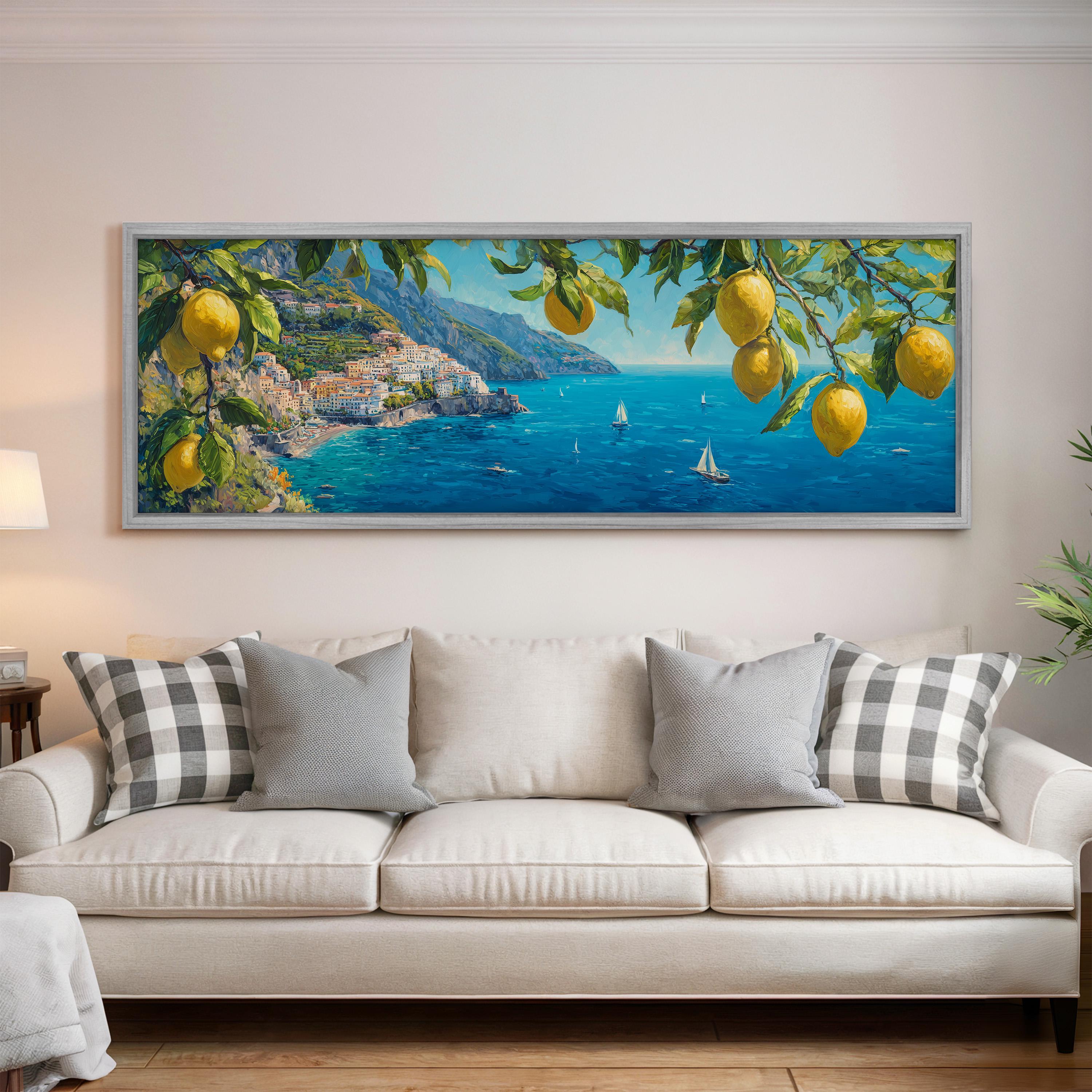 a large painting of a coastal scene with lemon trees and sailboats in the background, hanging on a wall above a white sofa with patterned throw pillows.