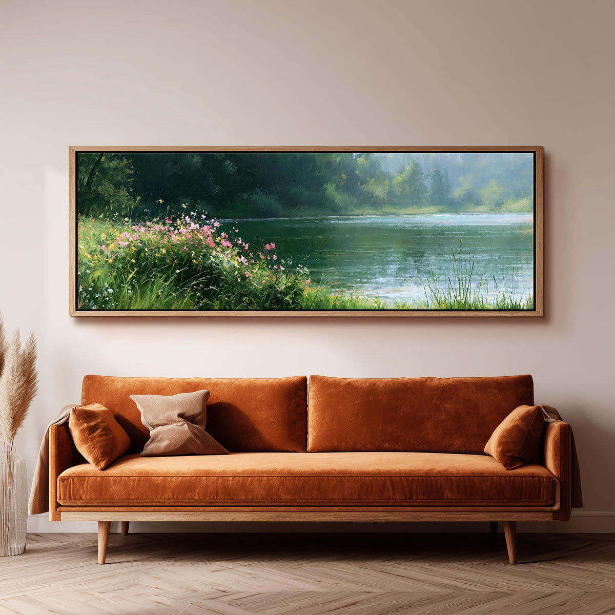 Pink wildflowers on a green lakeshore panoramic canvas print above a sofa in a living room