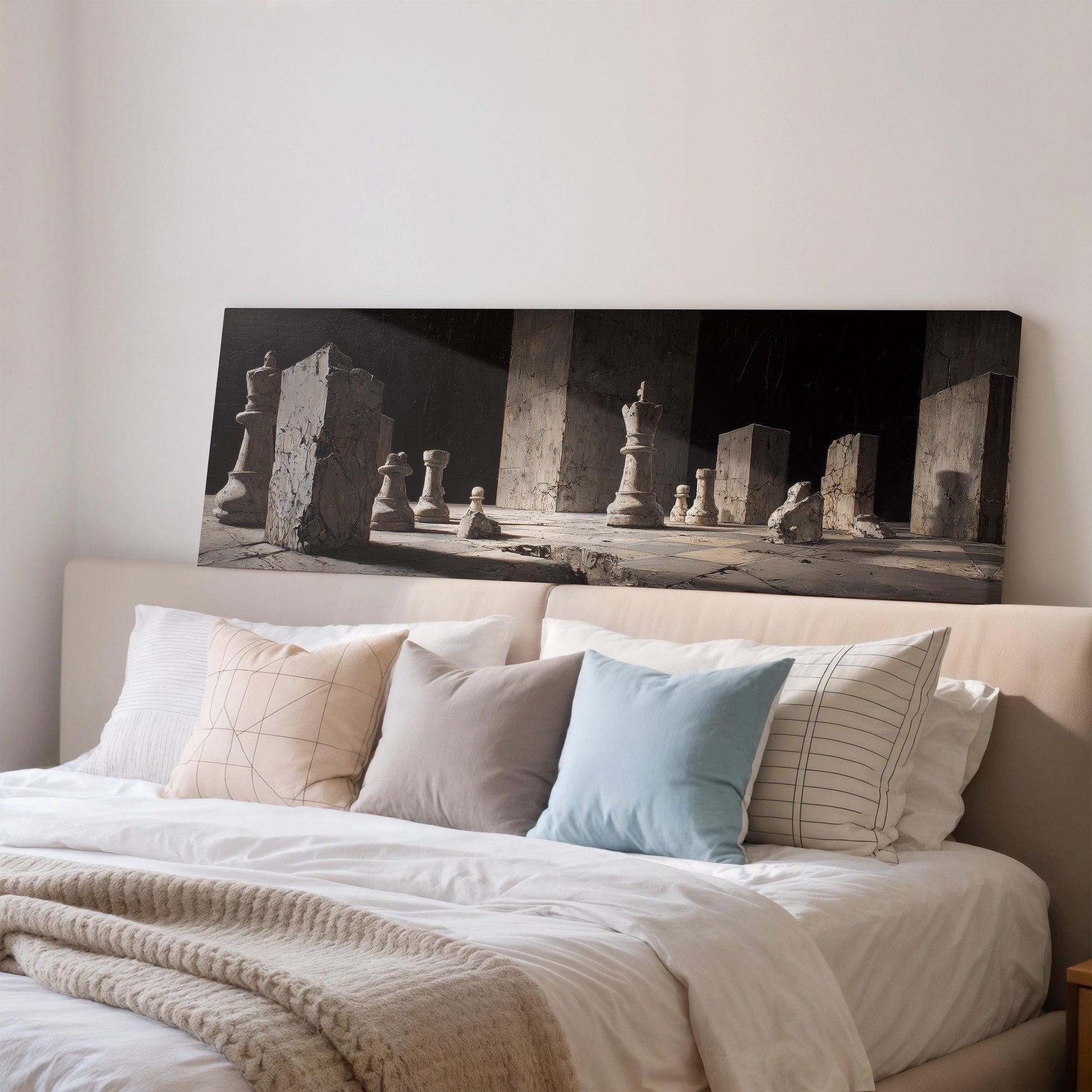 a large black and white photograph of chess pieces on a bed, with a beige headboard and white bedding.