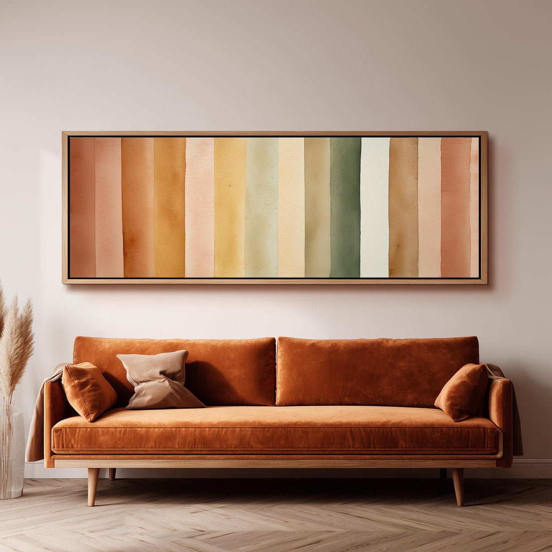 a large, vibrant orange couch with a wooden frame, positioned in front of a wall with a framed abstract painting above it.