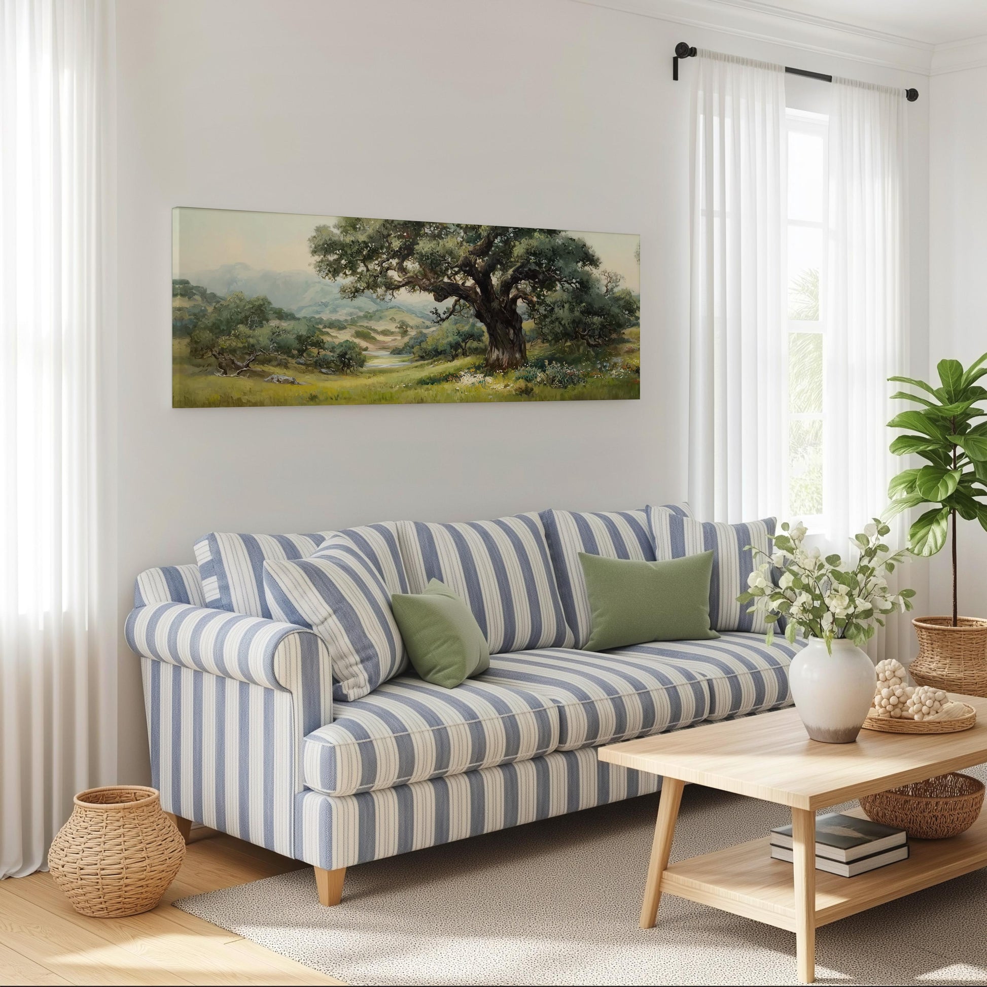 a cozy living room with a striped blue and white sofa, a wooden coffee table, and a large painting of a lush green landscape hanging on the wall.