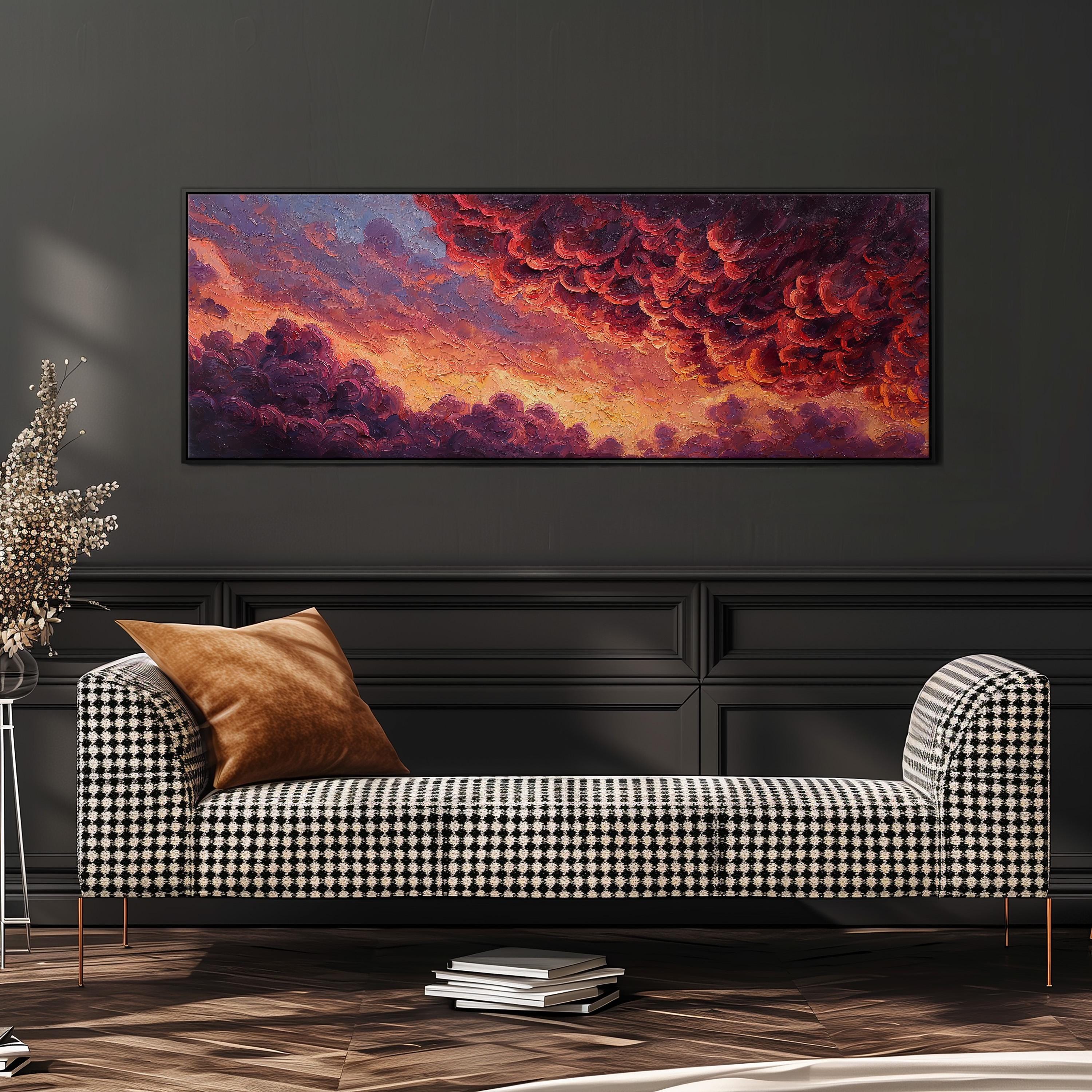 a large, colorful painting of a dramatic cloud formation hanging on a wall above a black and white checkered sofa.