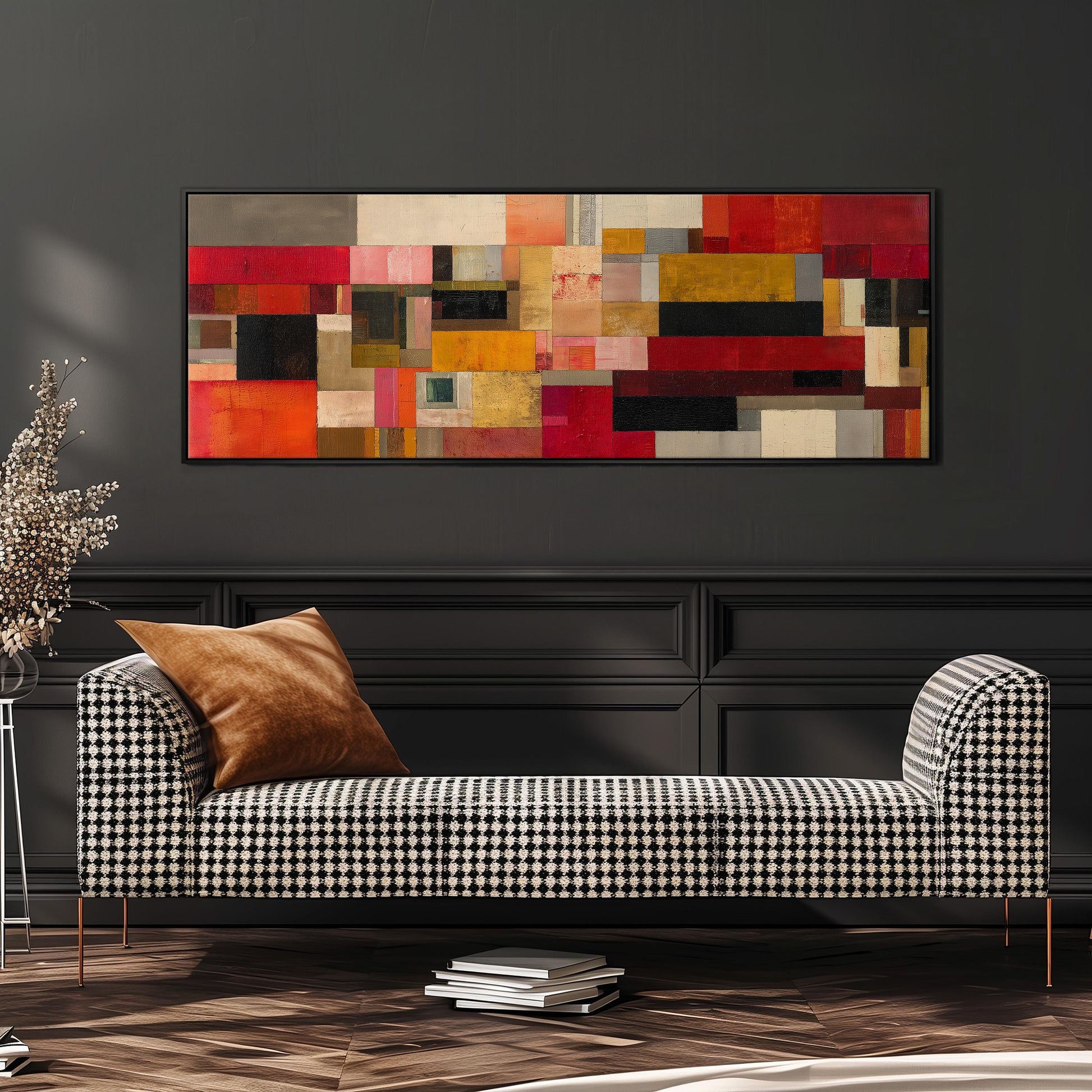 a modern living room with a black and white checkered sofa, a large abstract painting on the wall, and a stack of books on the floor.