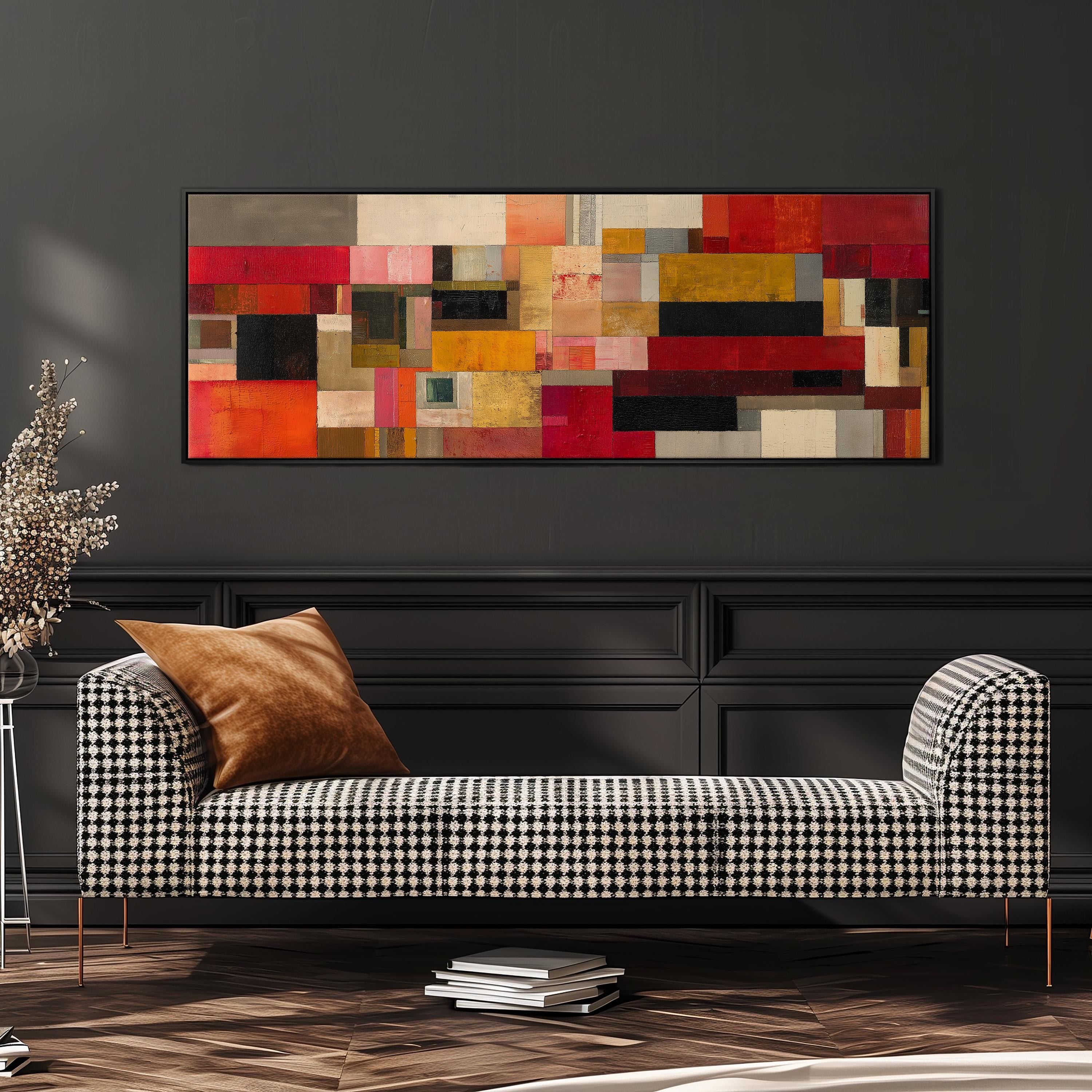 a modern living room with a black and white checkered sofa, a large abstract painting on the wall, and a stack of books on the floor.