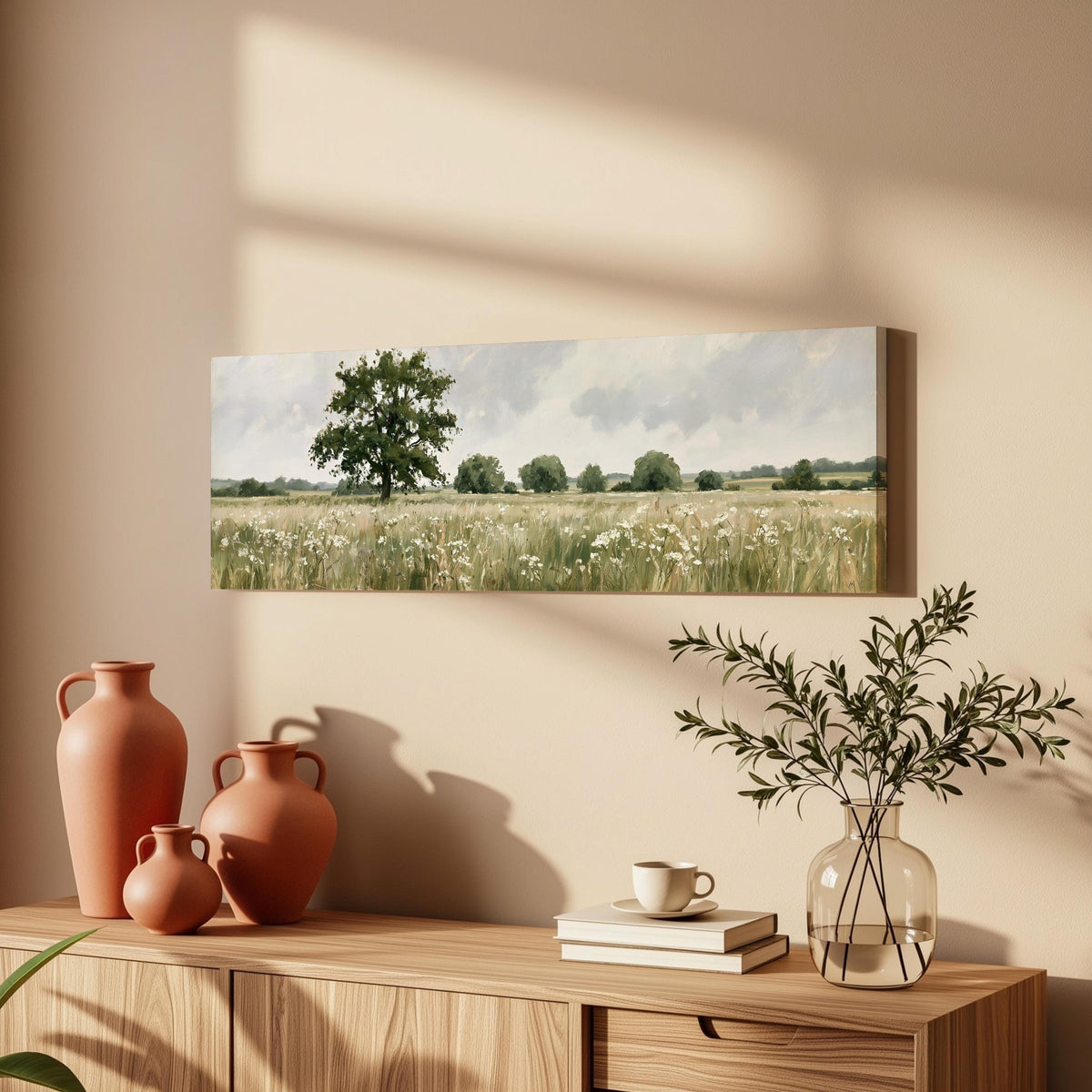 Lone oak tree in a daisy meadow long horizontal canvas print above a wooden sideboard