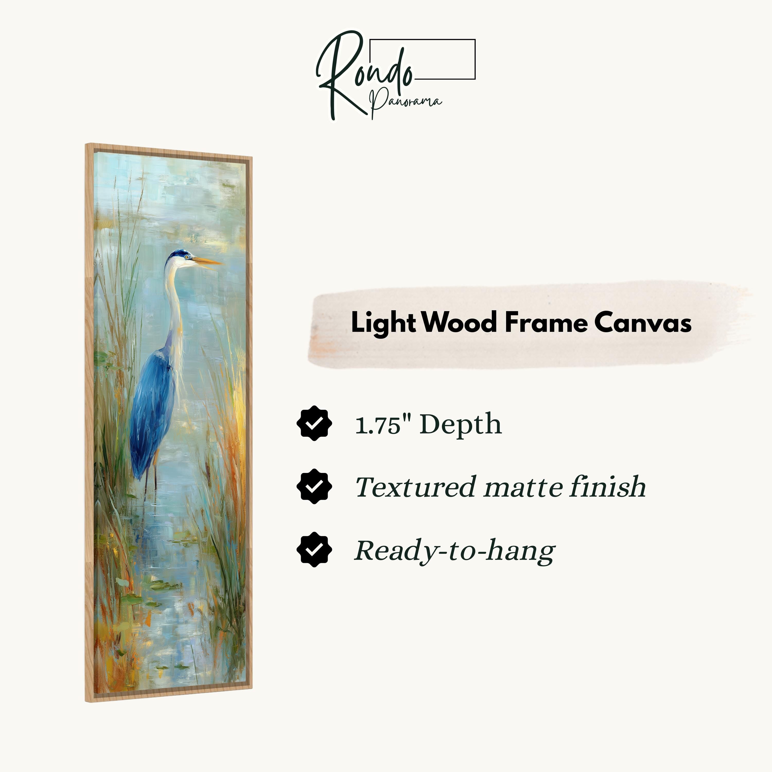 The image is a light wood frame canvas depicting a blue heron standing in tall grass.