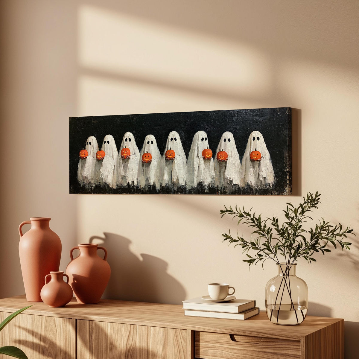 Crowd of huddled ghosts with pumpkins long horizontal canvas print above a wooden sideboard