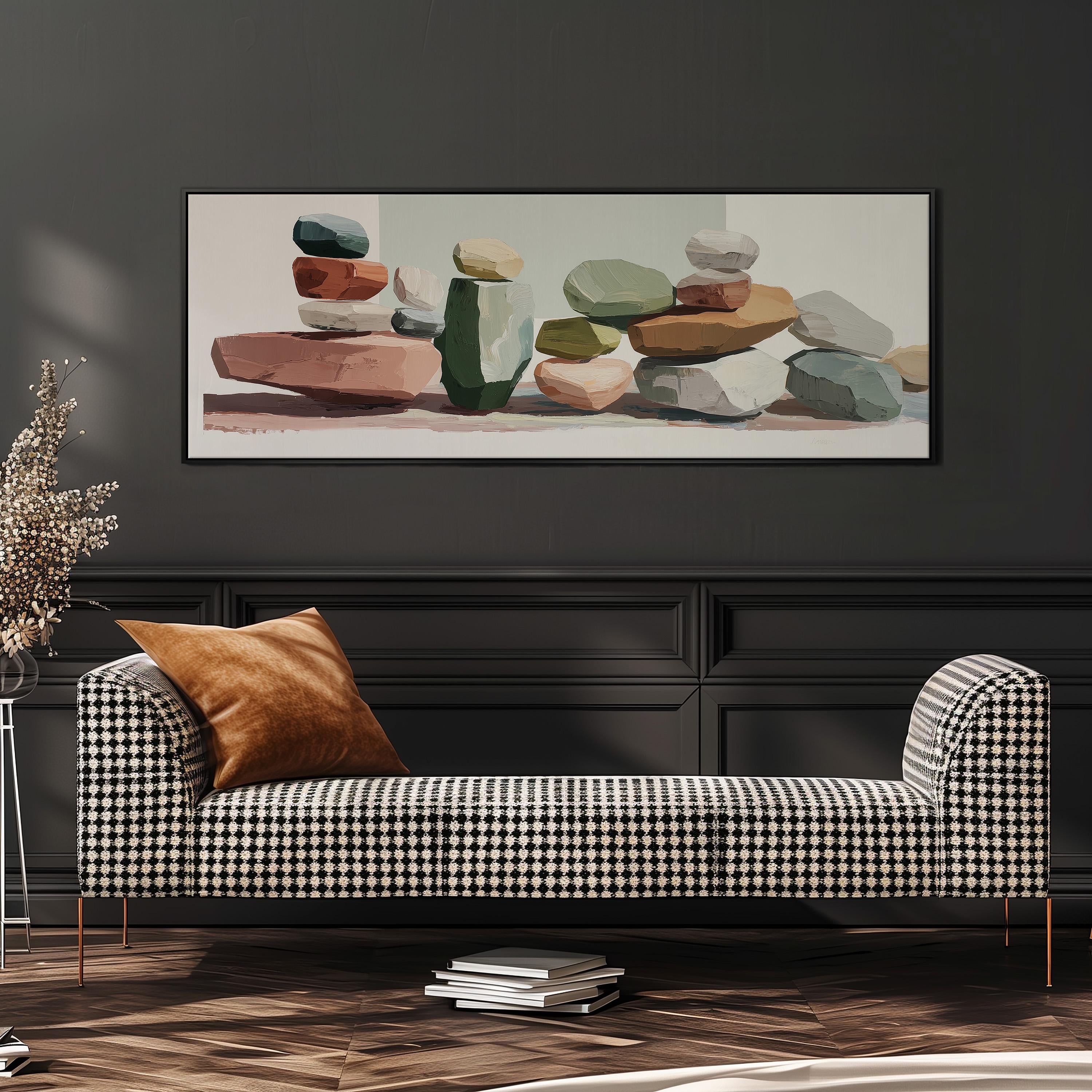 a black and white checkered sofa with a brown throw pillow, set against a dark wall with a framed abstract painting of stacked rocks above it.