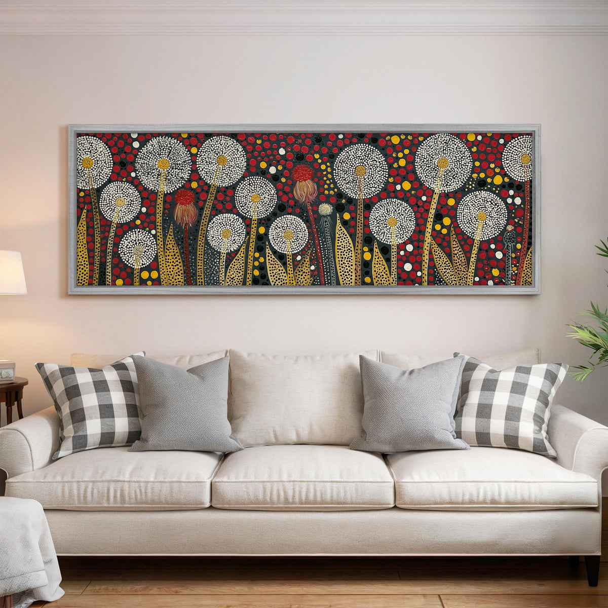 Dotted dandelions on deep red panoramic canvas print above a white sofa in a bright living room