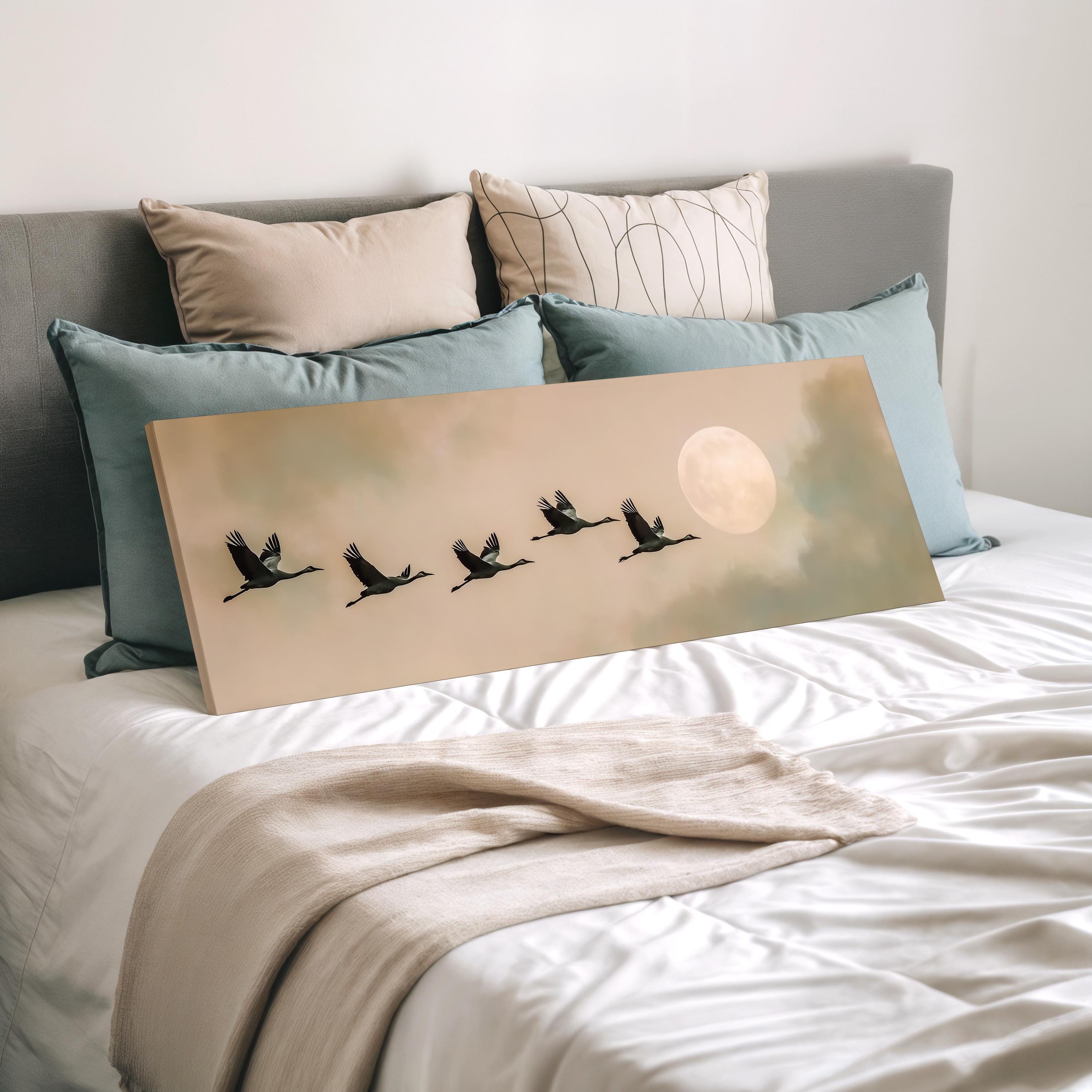 a large canvas print of a flock of birds flying in formation, with a full moon in the background.