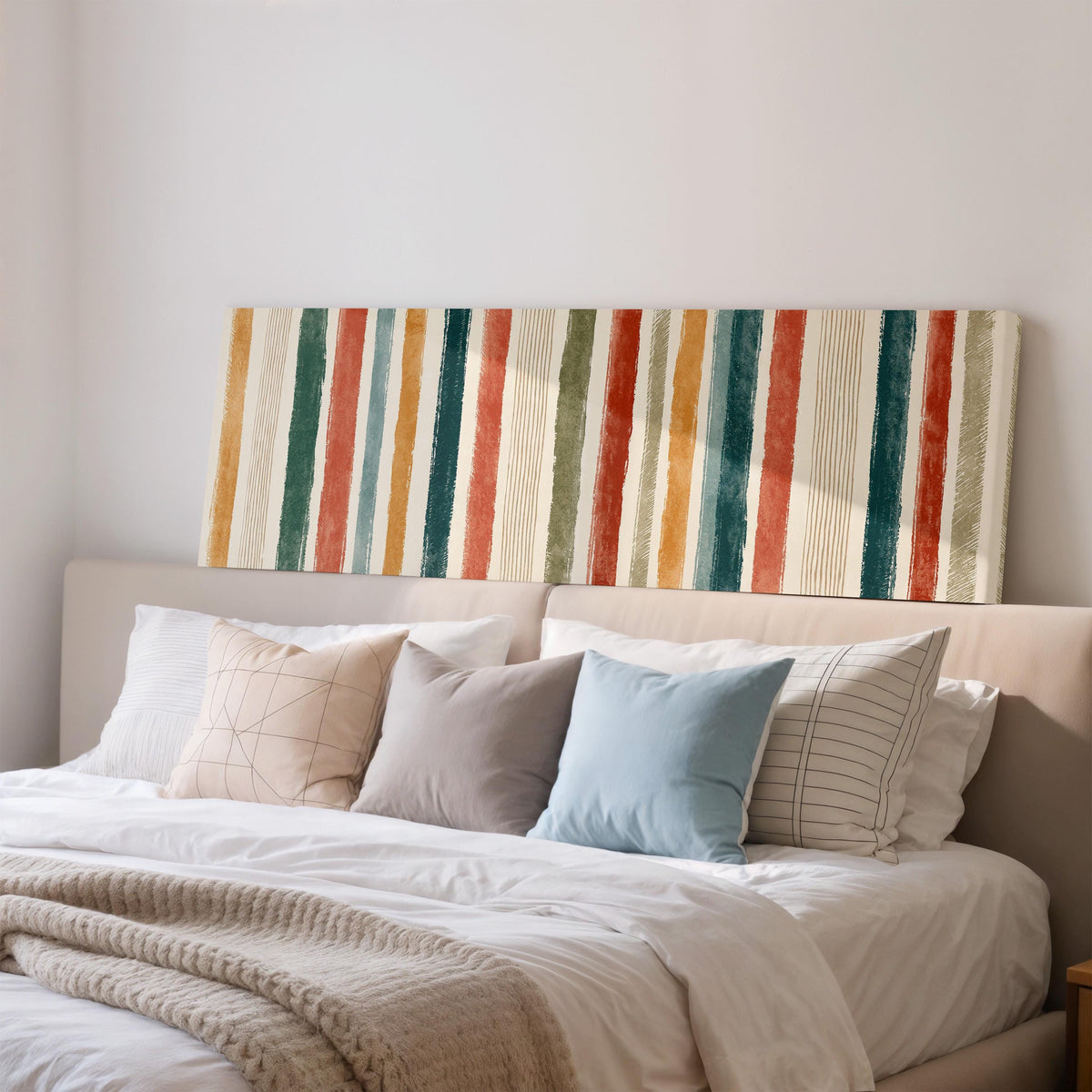 Boho watercolor stripes in mustard, teal and rust wide panoramic canvas print above a bed in a bedroom