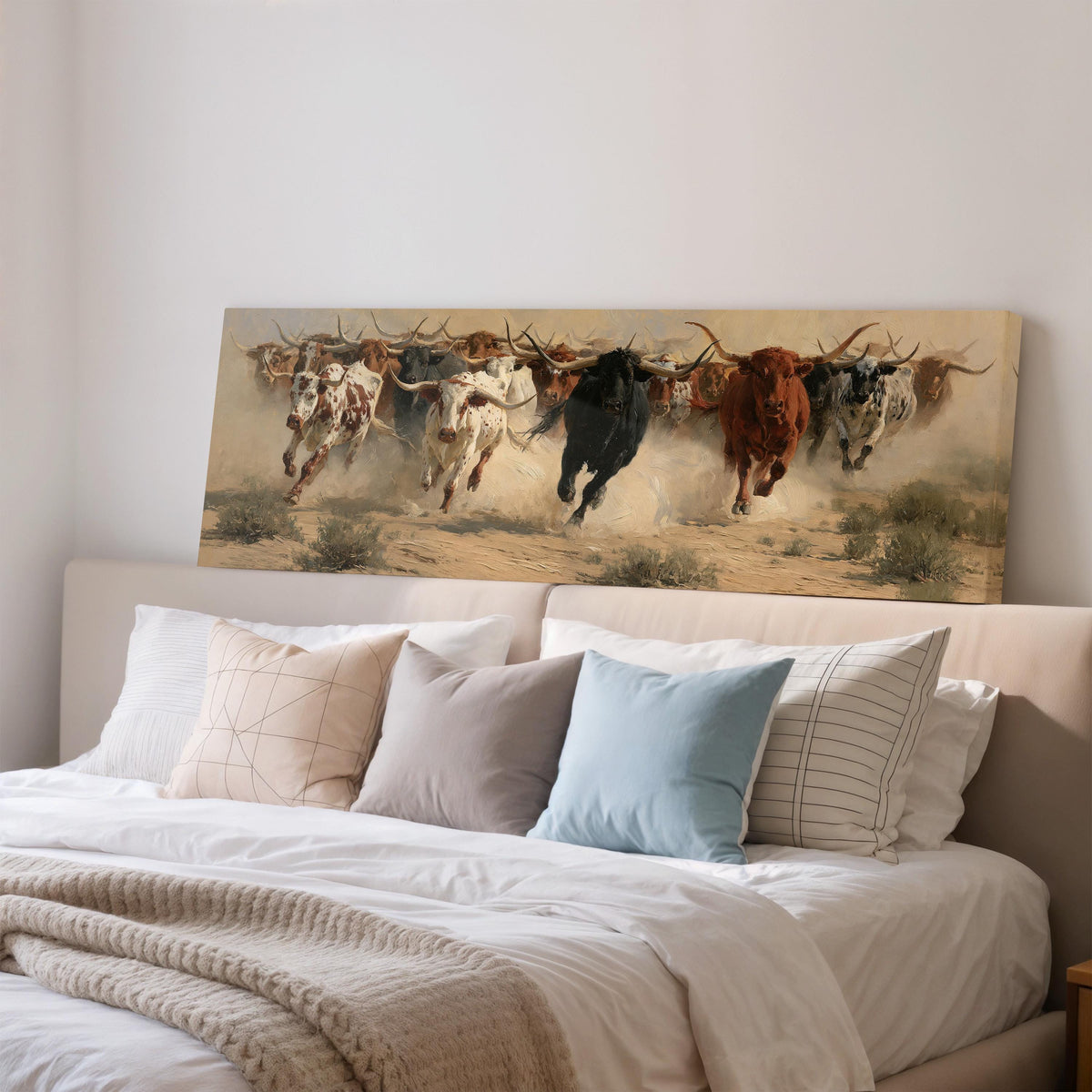 Charging longhorn herd wide panoramic canvas print above a bed in a bedroom