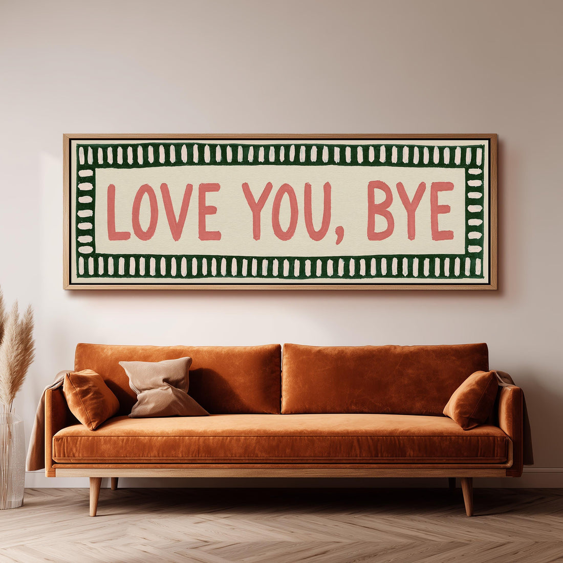 Love you, bye sign with a green border long horizontal canvas print above a sofa in a living room