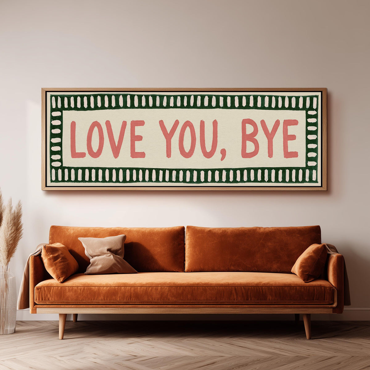 Love you, bye sign with a green border panoramic canvas print above a sofa in a living room