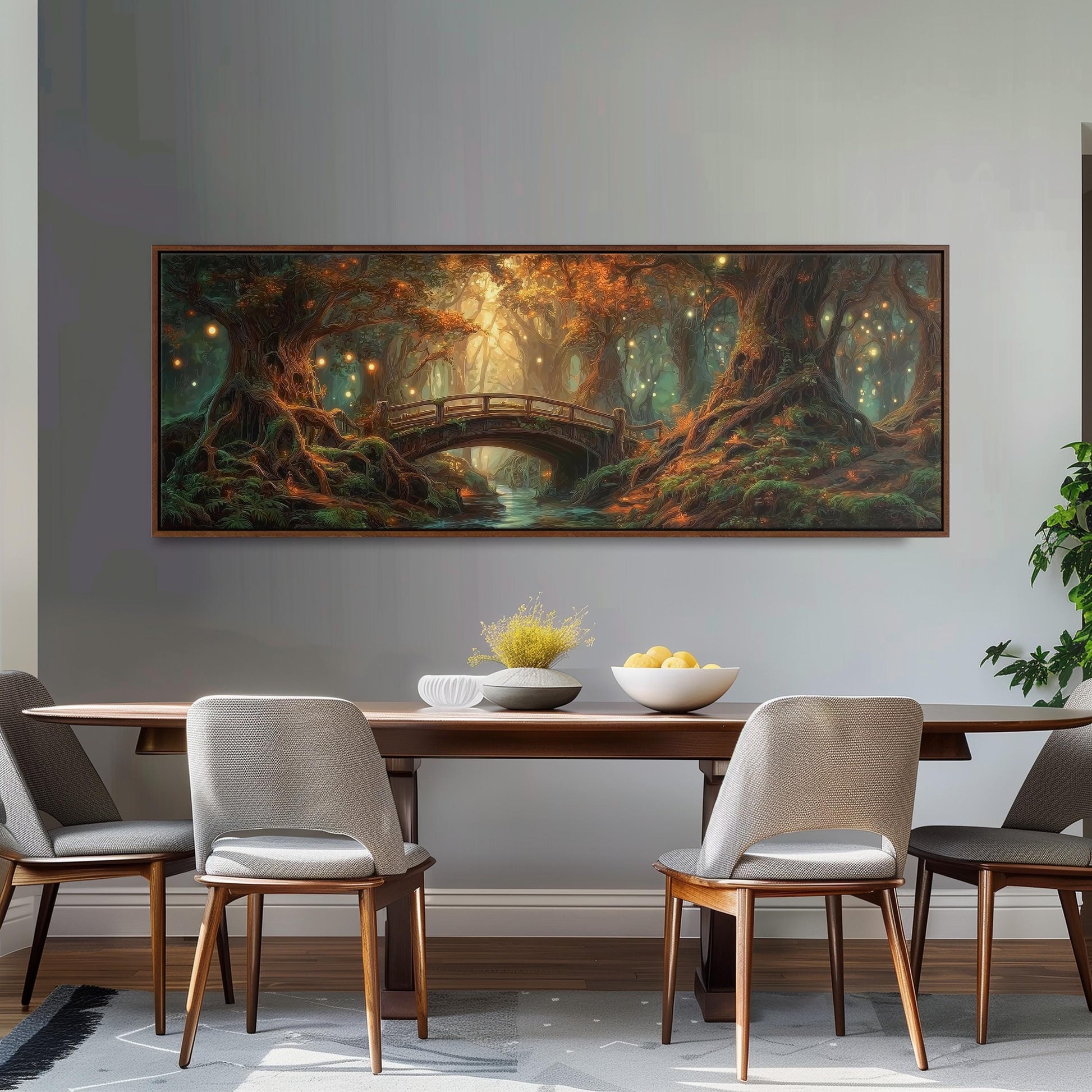 a large painting of a forest scene hanging on a wall above a wooden dining table with four chairs. The painting depicts a bridge, trees, and a stream, creating a serene and natural atmosphere.