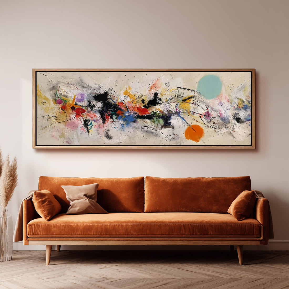 a large abstract painting hanging on a wall above a brown sofa with two pillows.