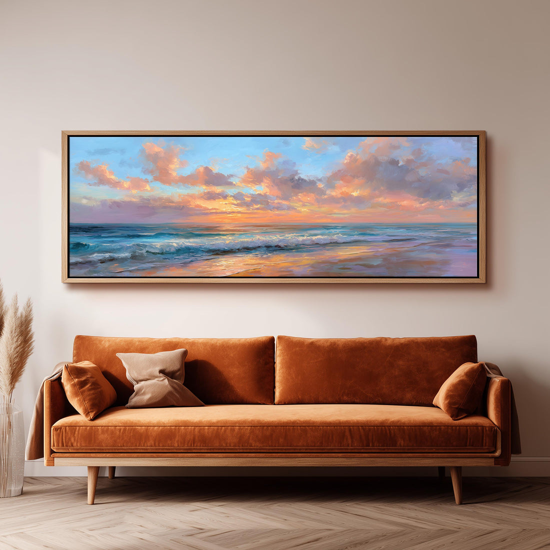 a large, rectangular painting of a serene beach scene hanging on a wall above a brown sofa.