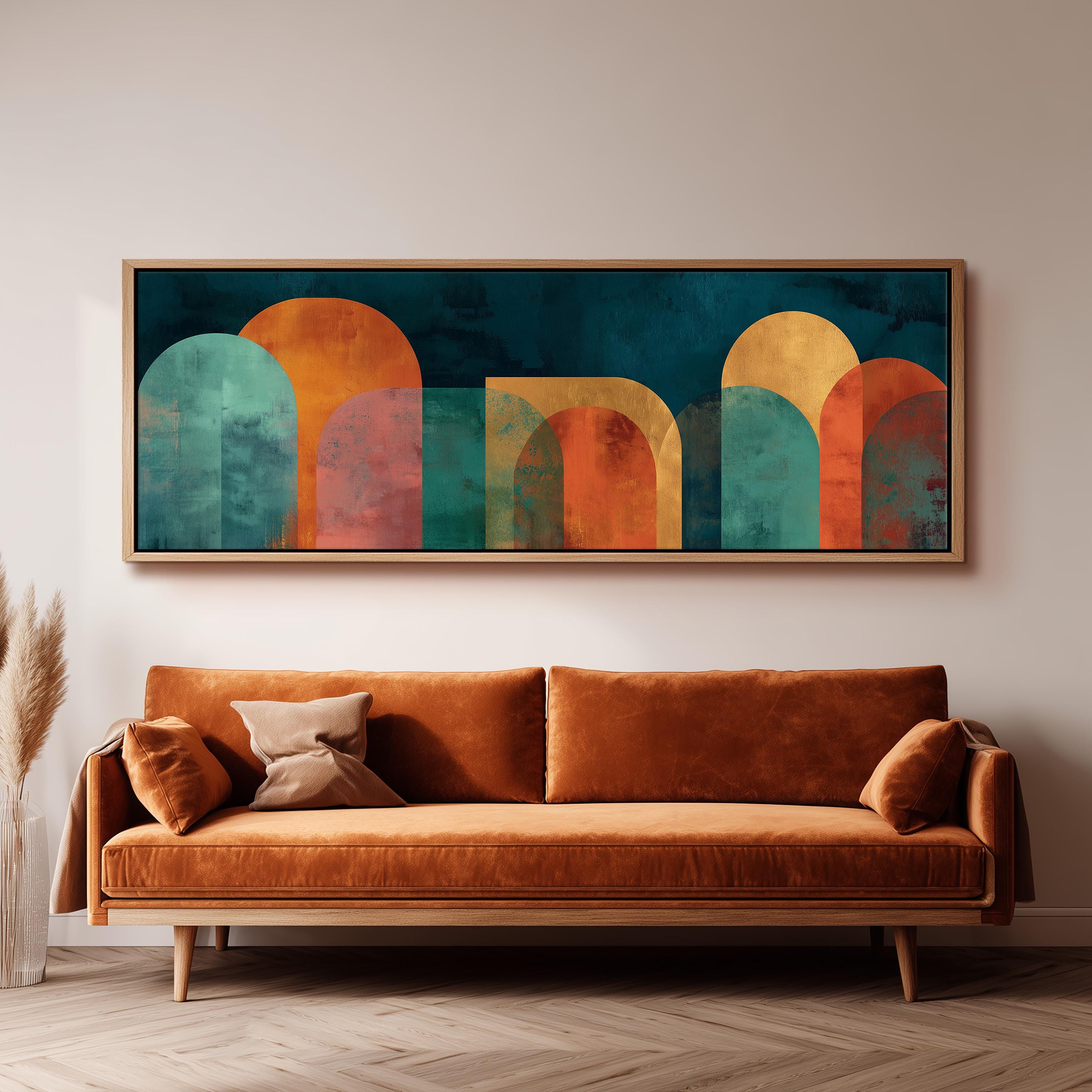a large abstract painting hanging on a wall above a brown sofa with two pillows.