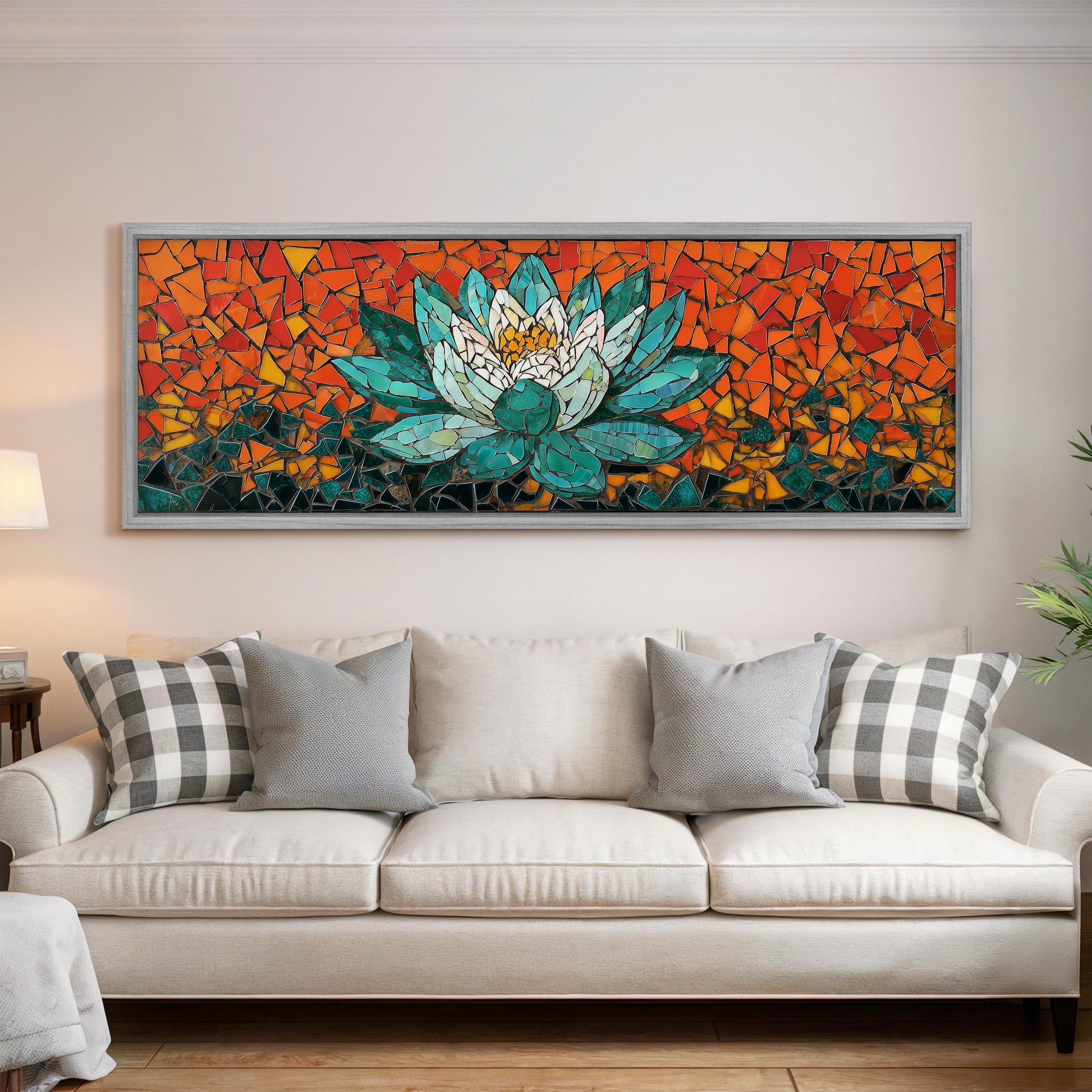 a large, colorful mosaic artwork depicting a lotus flower, which is hanging on the wall above a white couch in a living room setting.