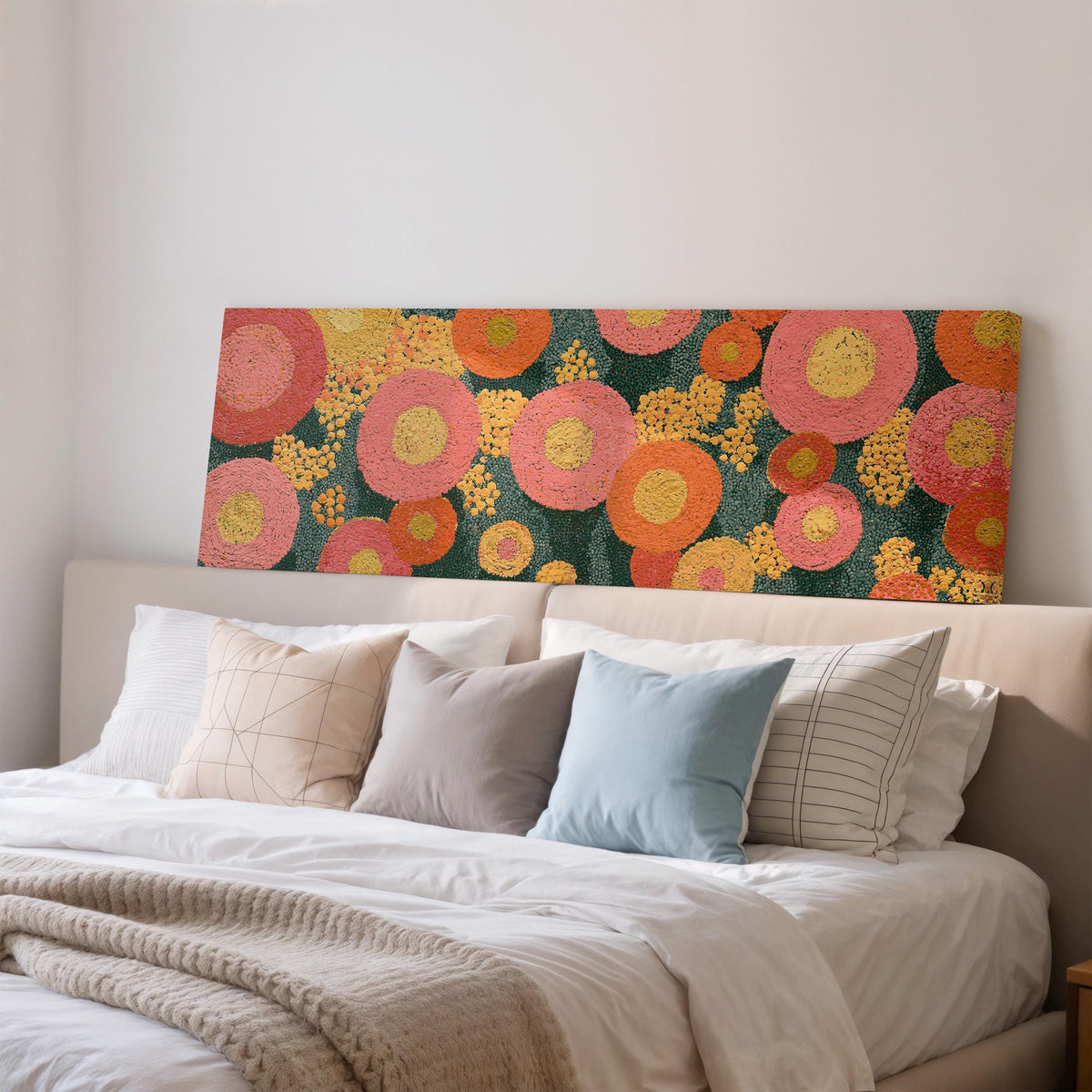 Pink circle blooms wide panoramic canvas print above a bed in a bedroom