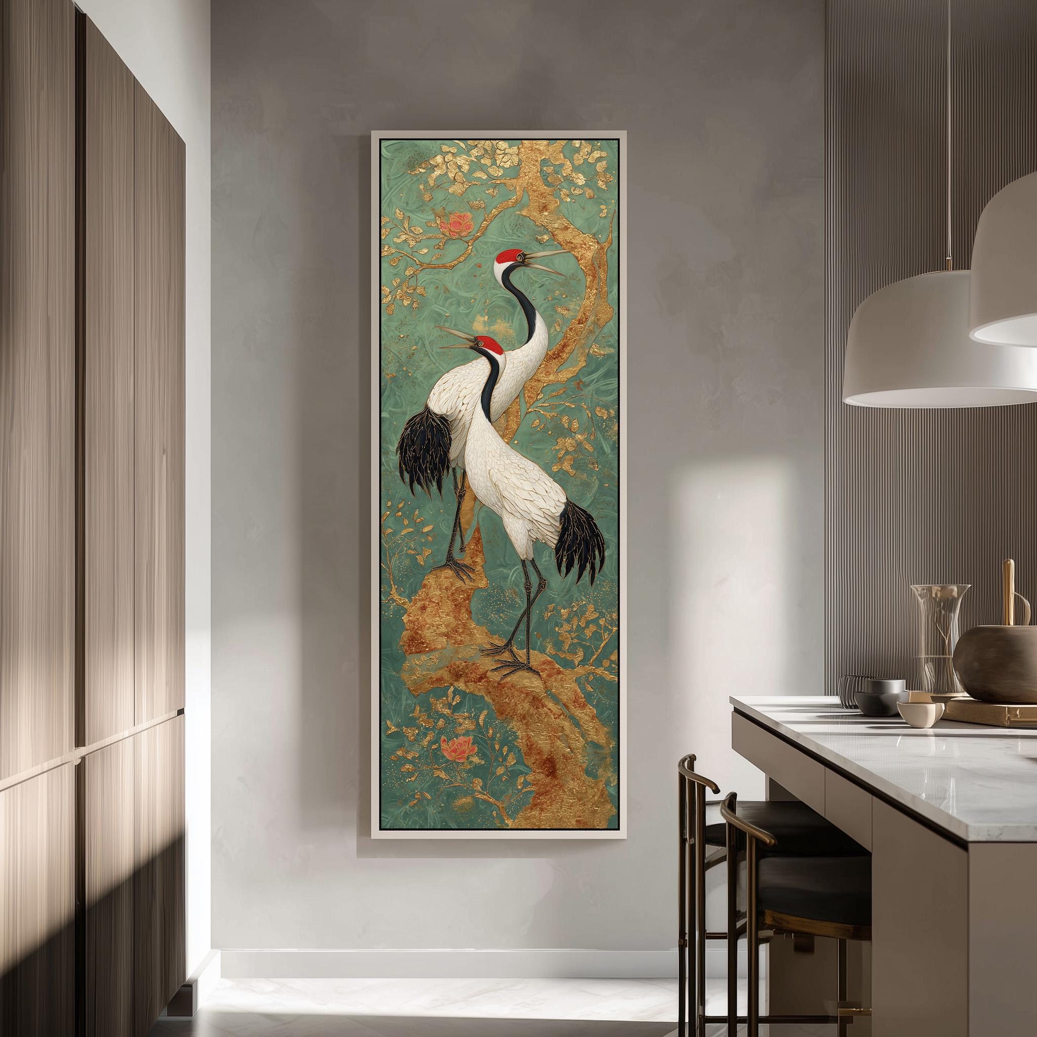 a large framed painting of two white birds with black and red accents, standing on a branch with flowers, hanging on a wall in a modern kitchen.