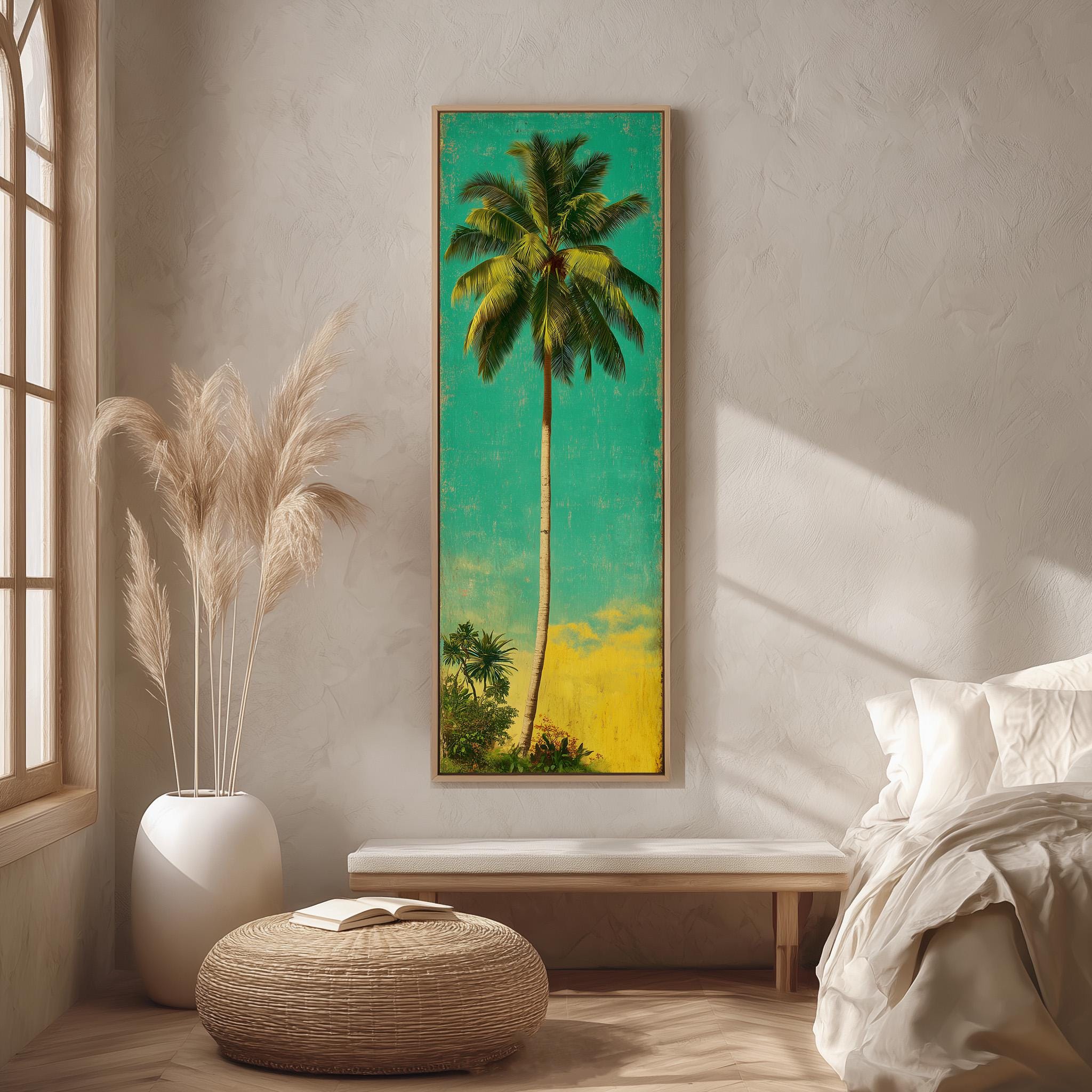 a large tropical painting of a palm tree hanging on a wall in a room with a bed, a wicker ottoman, and a potted plant.