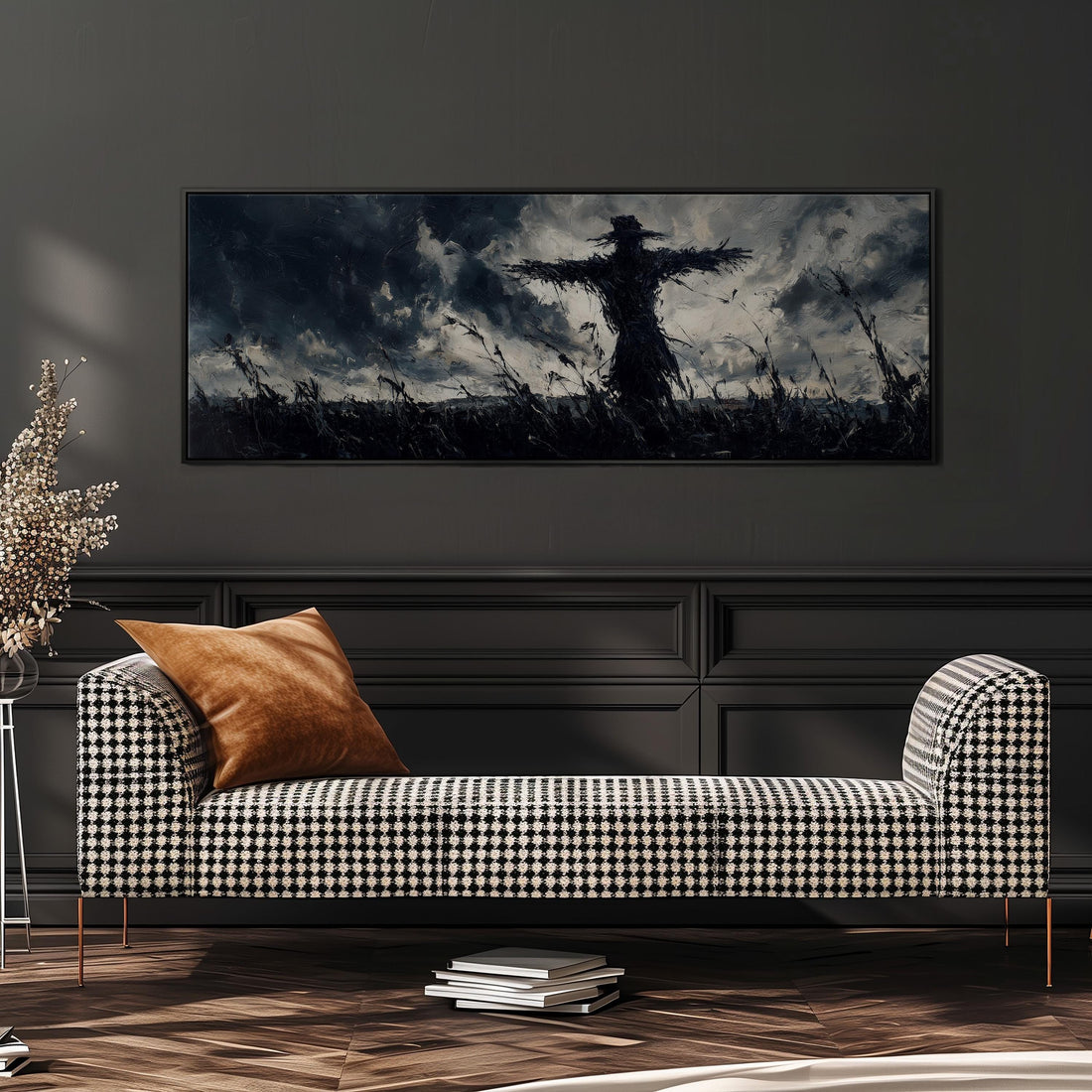 a large black and white photograph of a scarecrow in a field, hanging on a wall above a black and white checkered sofa.
