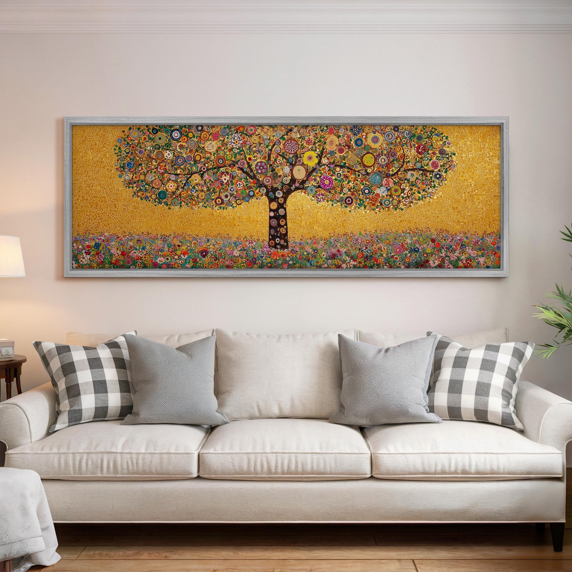 a large, colorful painting of a tree hanging on a wall above a white couch with gray and white pillows.