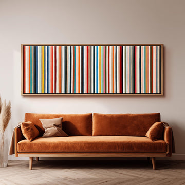 Rainbow pinstripes long horizontal canvas print above a sofa in a living room