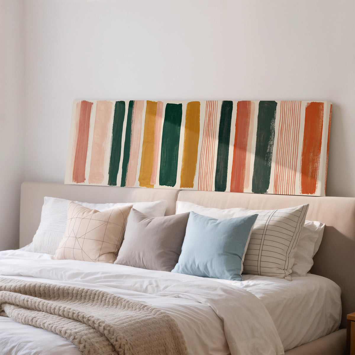 Mixed stripe blocks in terracotta, pink and green wide panoramic canvas print above a bed in a bedroom