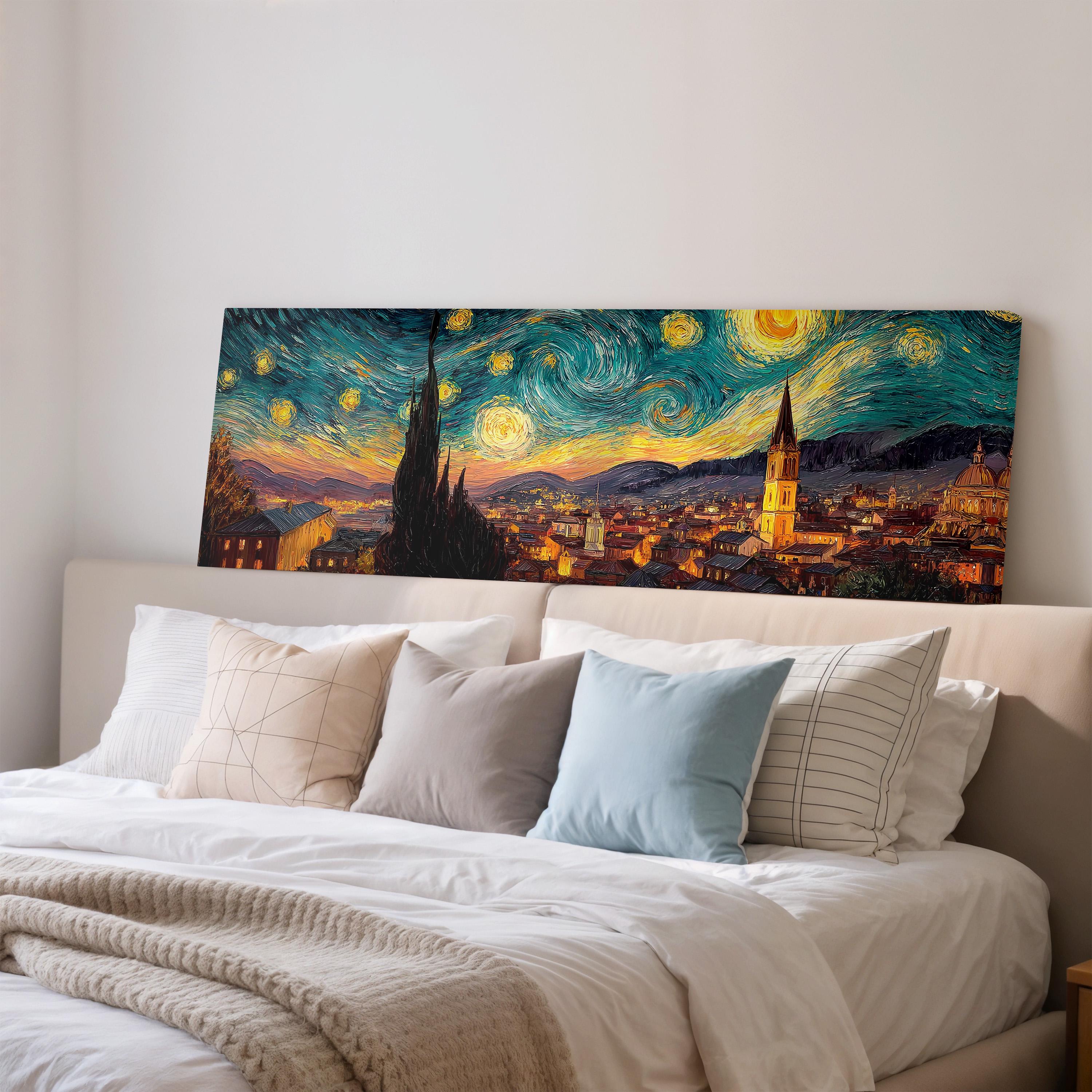 a large, colorful painting of a cityscape with a starry night sky above, hanging on a wall above a bed with white pillows and a gray blanket.