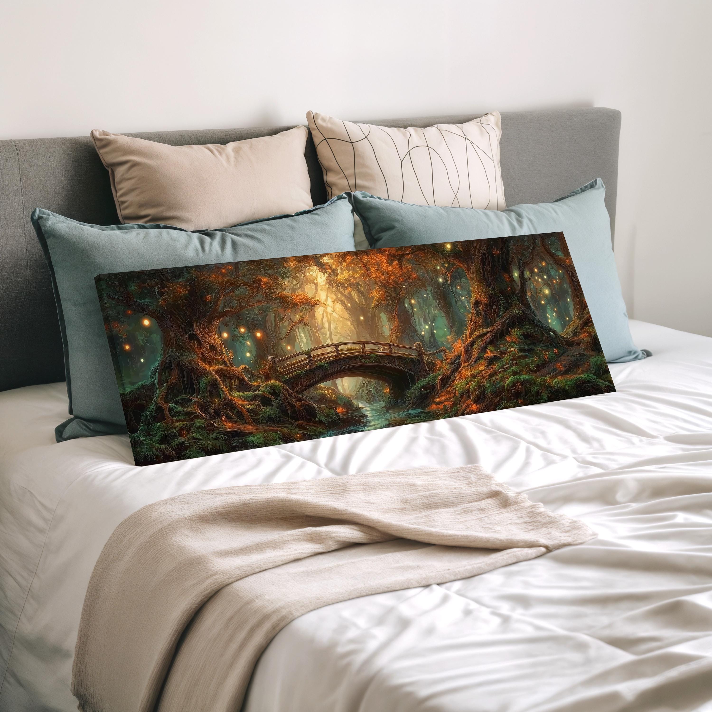 a large, colorful painting of a forest scene with a bridge in the background, displayed on a bed with pillows.